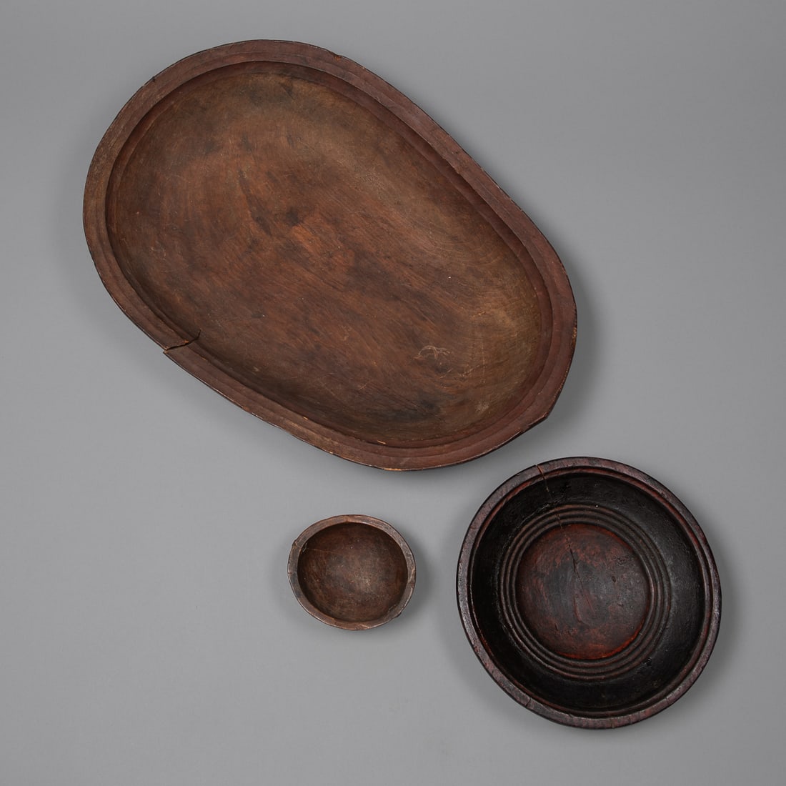 Three Antique Bering Sea Eskimo Carved Wood Food Bowls: 19th Century, a rare set of three antique Bering Sea Eskimo, Alaska, hand-carved wooden food bowls, dating to the 19th century. Two of the three bowls are documented and pictured in Eskimo Artifacts: