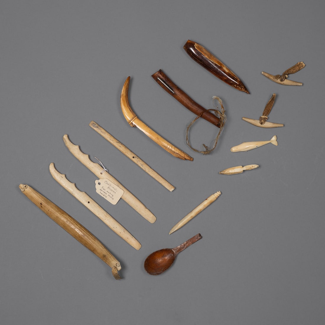 Thirteen Bering Sea Eskimo implements & figurative amulets (1 of 4)