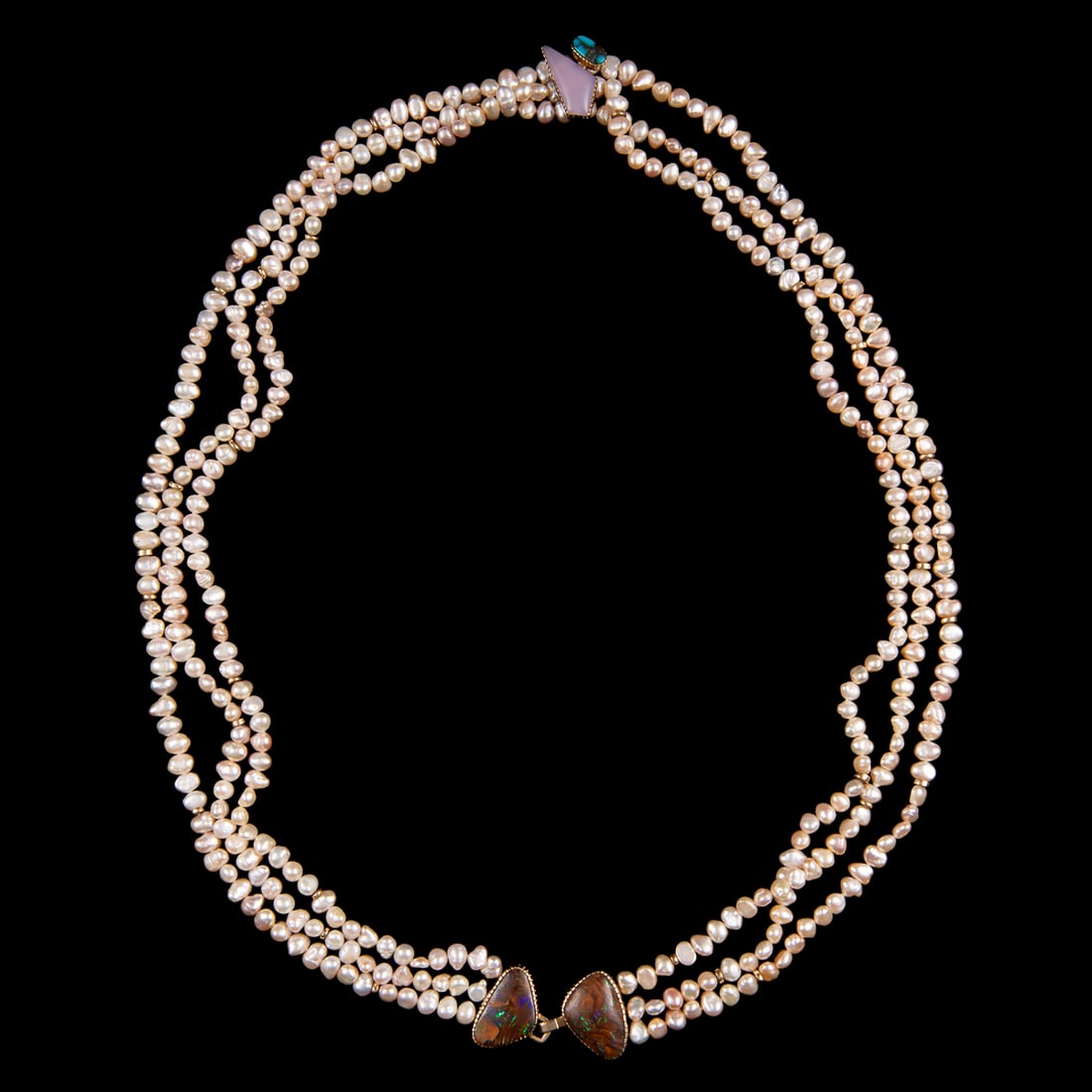A Gail Bird and Yazzie Johnson necklace: Kewa (Santo Domingo)/Laguna, (b. 1949) and Diné (Navajo), (b. 1946), the three-strand pearl beaded necklace, features 14 karat gold clasps with both maker’s mark, beading, and settings, the