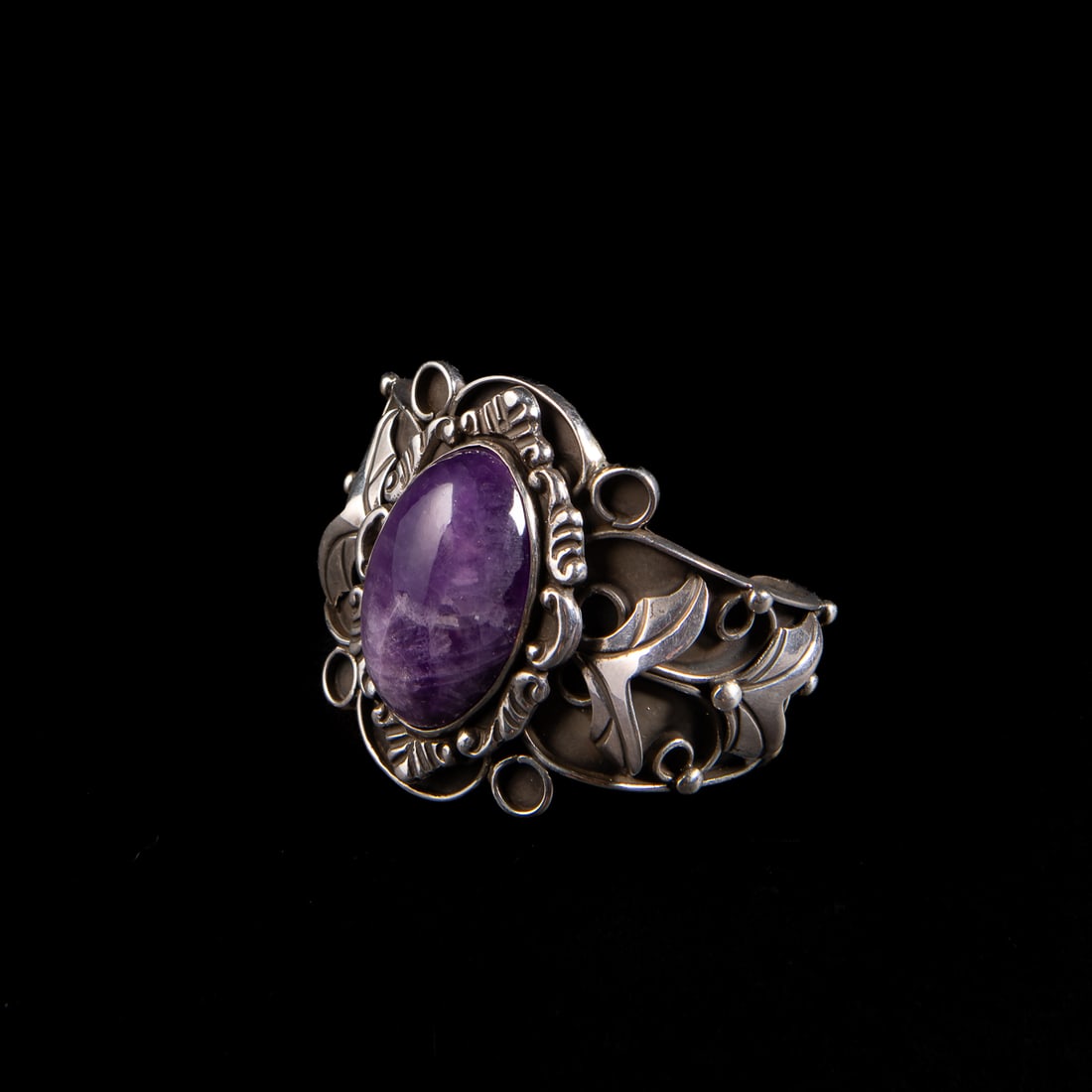 A Fred Davis silver cuff bracelet: The silver cuff with silver leaf and ball devices, the center with a large amethyst setting, marked with the Fred Davis symbol and “Made in Mexico silver.” Total interior circumference (includ
