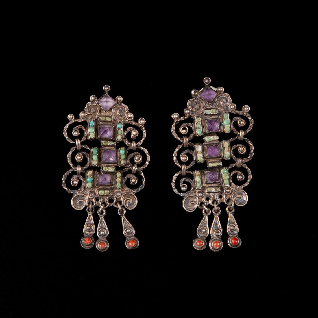 A pair of Matilde Poulat silver earrings: The silver earrings with three tiers of amethyst, coral, and turquoise settings, marked “Matl Mexico 925. Rag 141093.” Lg. 2 ¾, wd.1 1/4 in. Gross weight 21 grams.