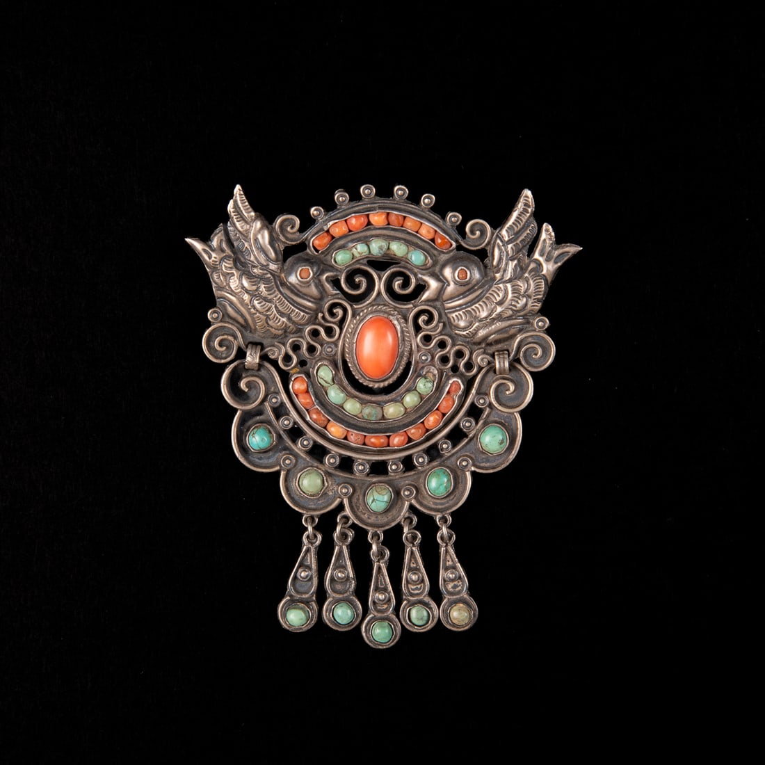 A Matilde Poulat silver, turquoise and coral pin: Matilde Poulat, Mexico City, circa 1950-1960, sterling silver broach, the two doves with hinged motif below, with coral and turquoise settings, signed verso “Matl Mexico 925.” Size 2 ¾