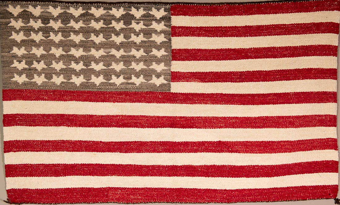 A Navajo United States flag weaving: A fifty star flag weaving in red, white and blue. Size 27" x 44 1/4 in.