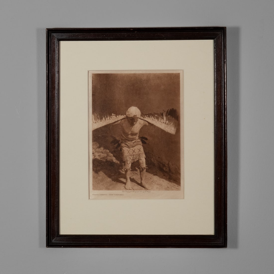 An Edward Sheriff Curtis photogravure: Edward Sheriff CurtisAnglo, (1868-1952), "Eagle Dancer - San Ildefonso," 1925, size of print 8 x 6, size of frame 13 3/4 x 11 1/2 in. Framed with archival mounting.