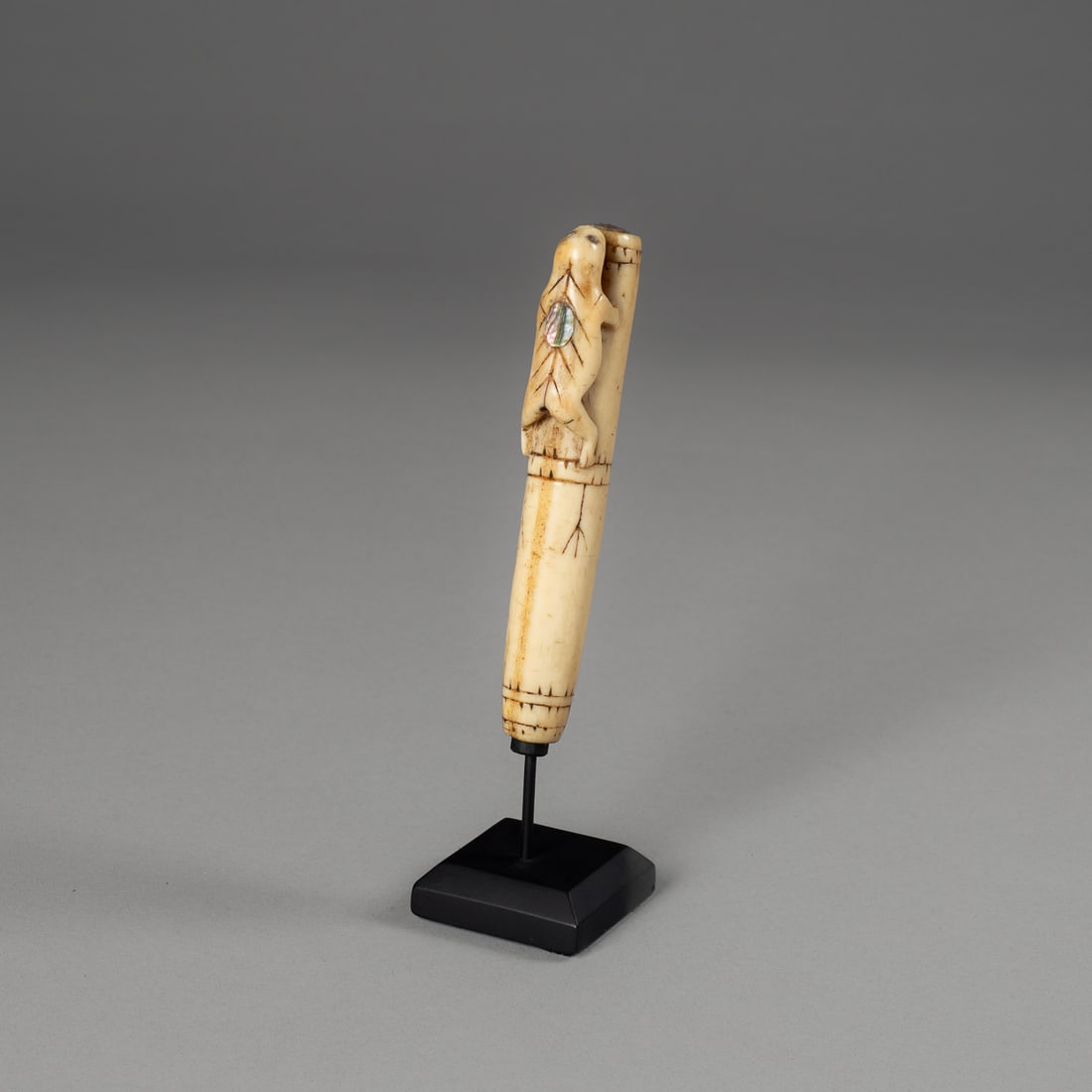 An outstanding Bering Sea Eskimo needle case: A superb and exceptionally rare antique Bering Sea Eskimo (Yupik) needle case, carved in two sections that slide together to protect the sewing needles stored within, an essential tool in Arctic mater