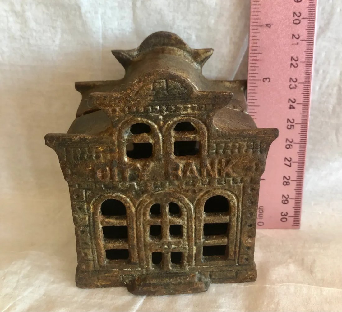 Cast Iron City Bank Still Bank: John Harper & Co. Cast iron still banked named City Bank. Bank is circa 1905. Has some minor surface rust. See pictures for condition. If bidding online feel free to contact us for more information. 4