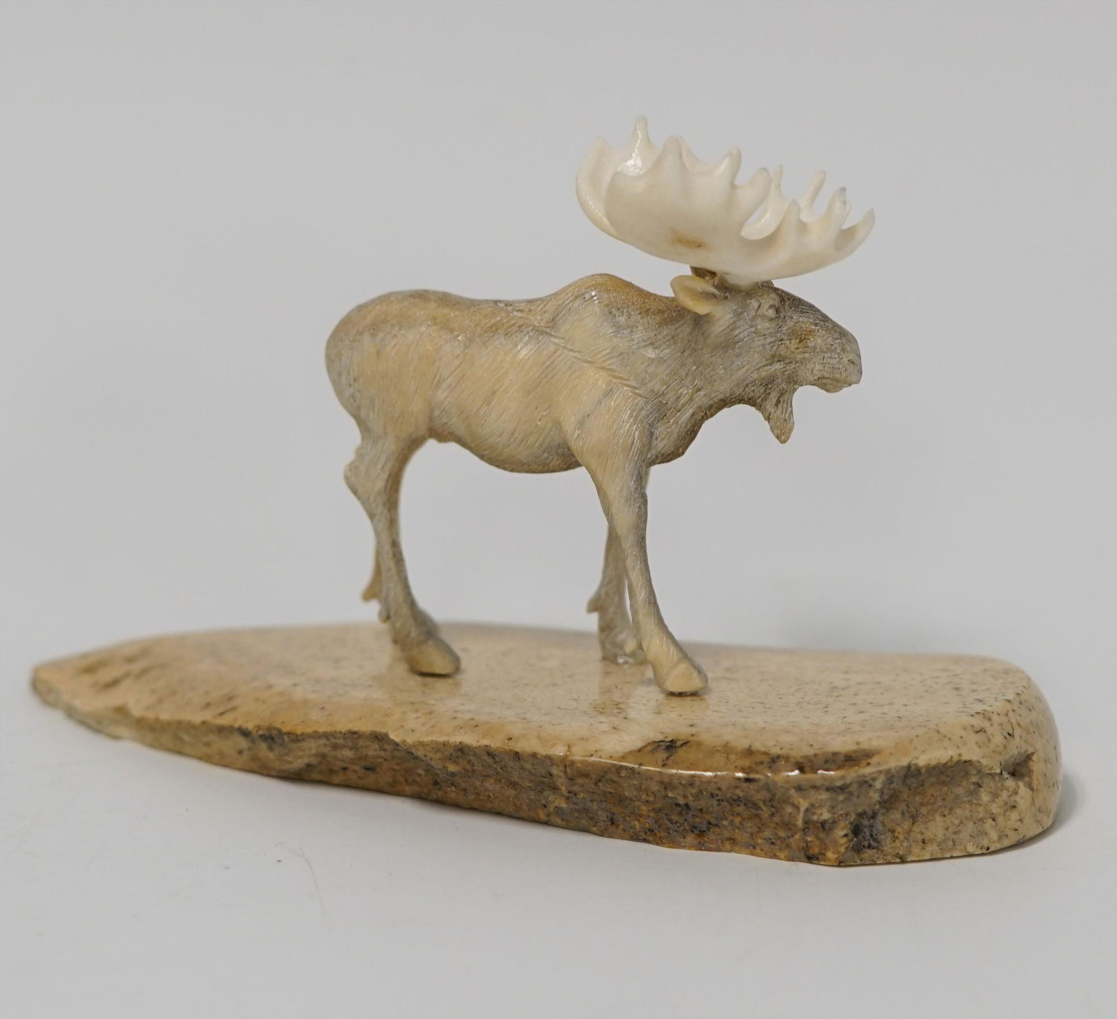 Michael Scott bone carving: Michael Scott bone carving of a moose on bone base, 4.75" long (P 22)