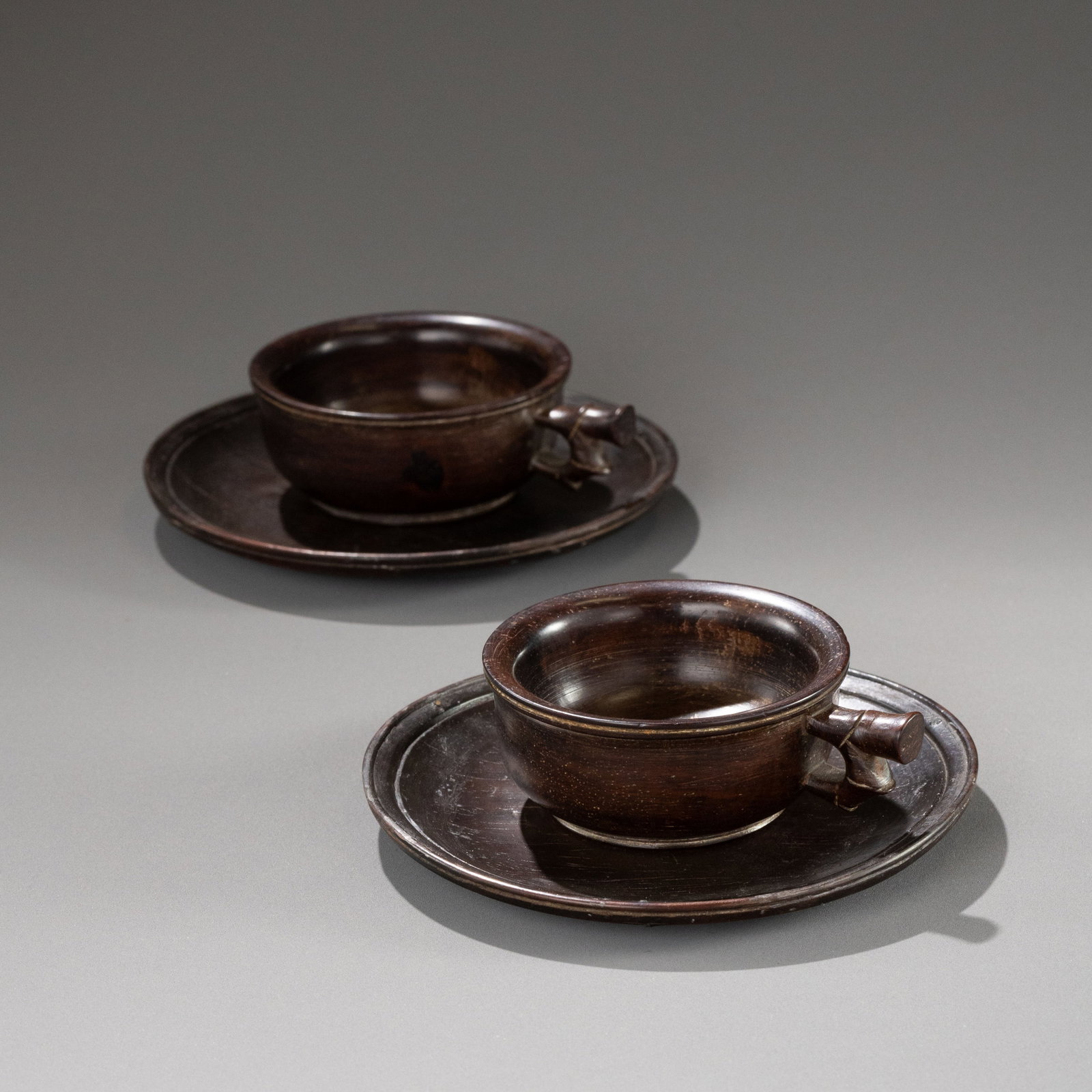 A pair of Qing Dynasty rosewood teacups and saucers: W: 11cm H: 3cm x2