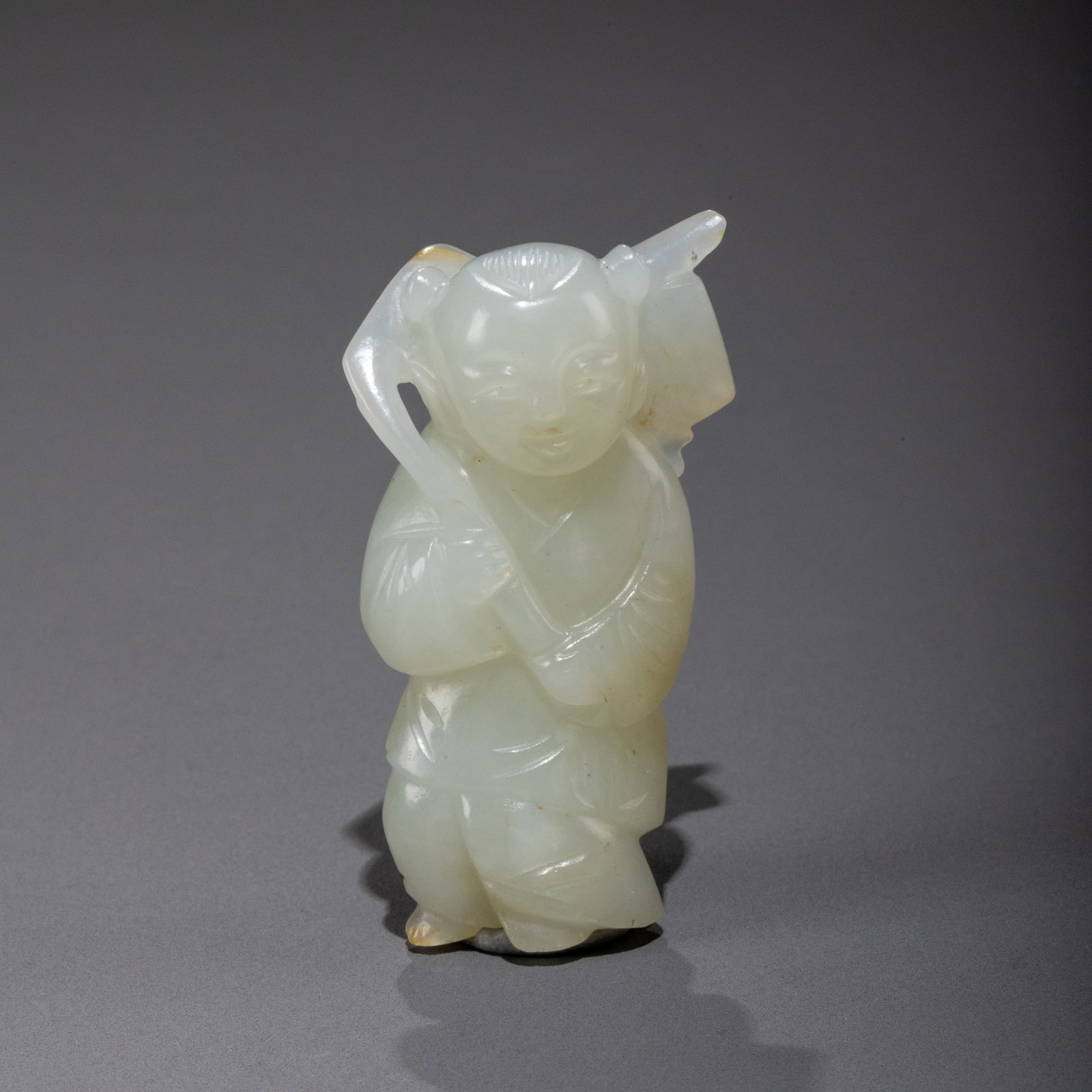 A white jade carving of a child symbolizing continuous happiness. (1 of 10)