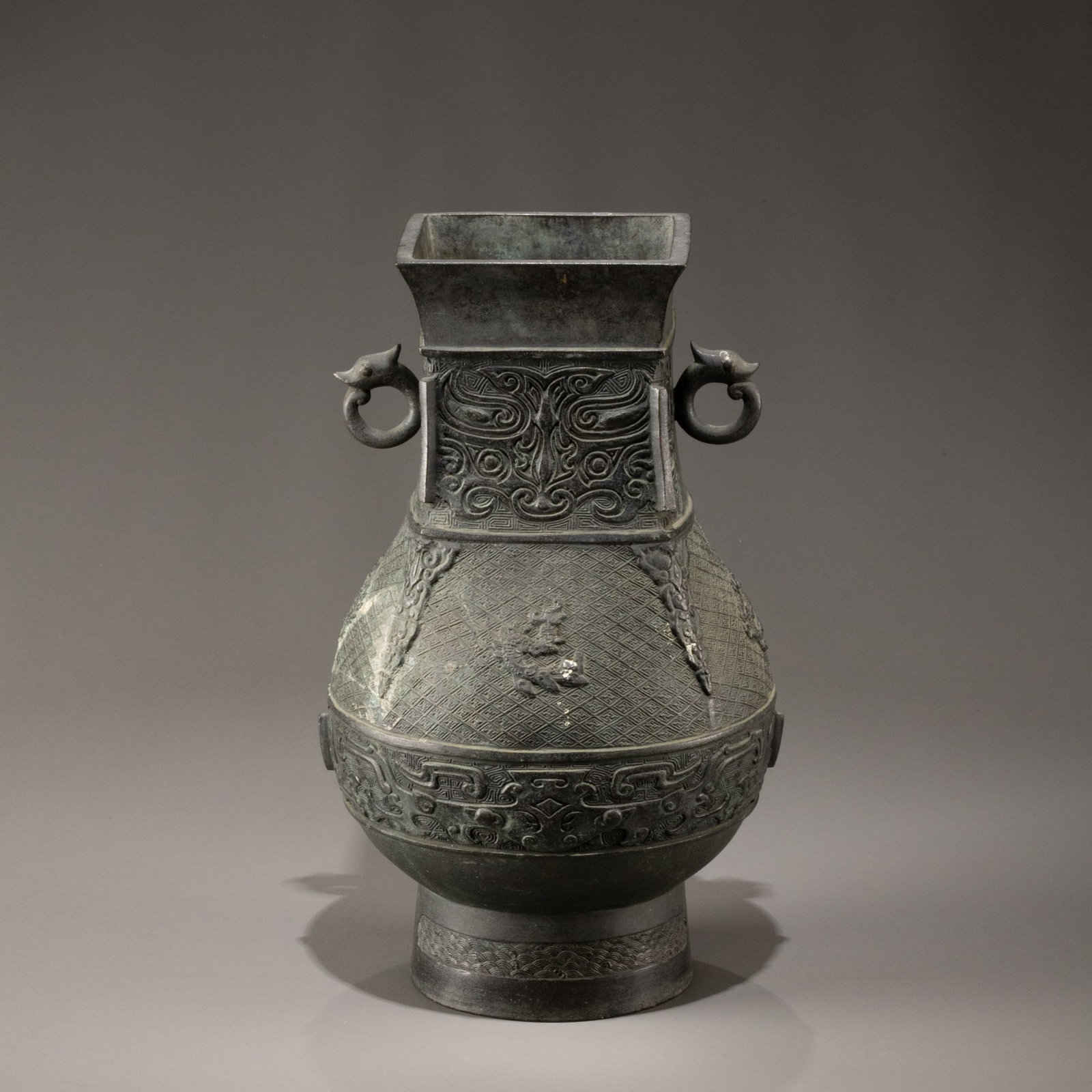 Bronze double-eared pot with animal mask design: H: 30cm W: 18cm