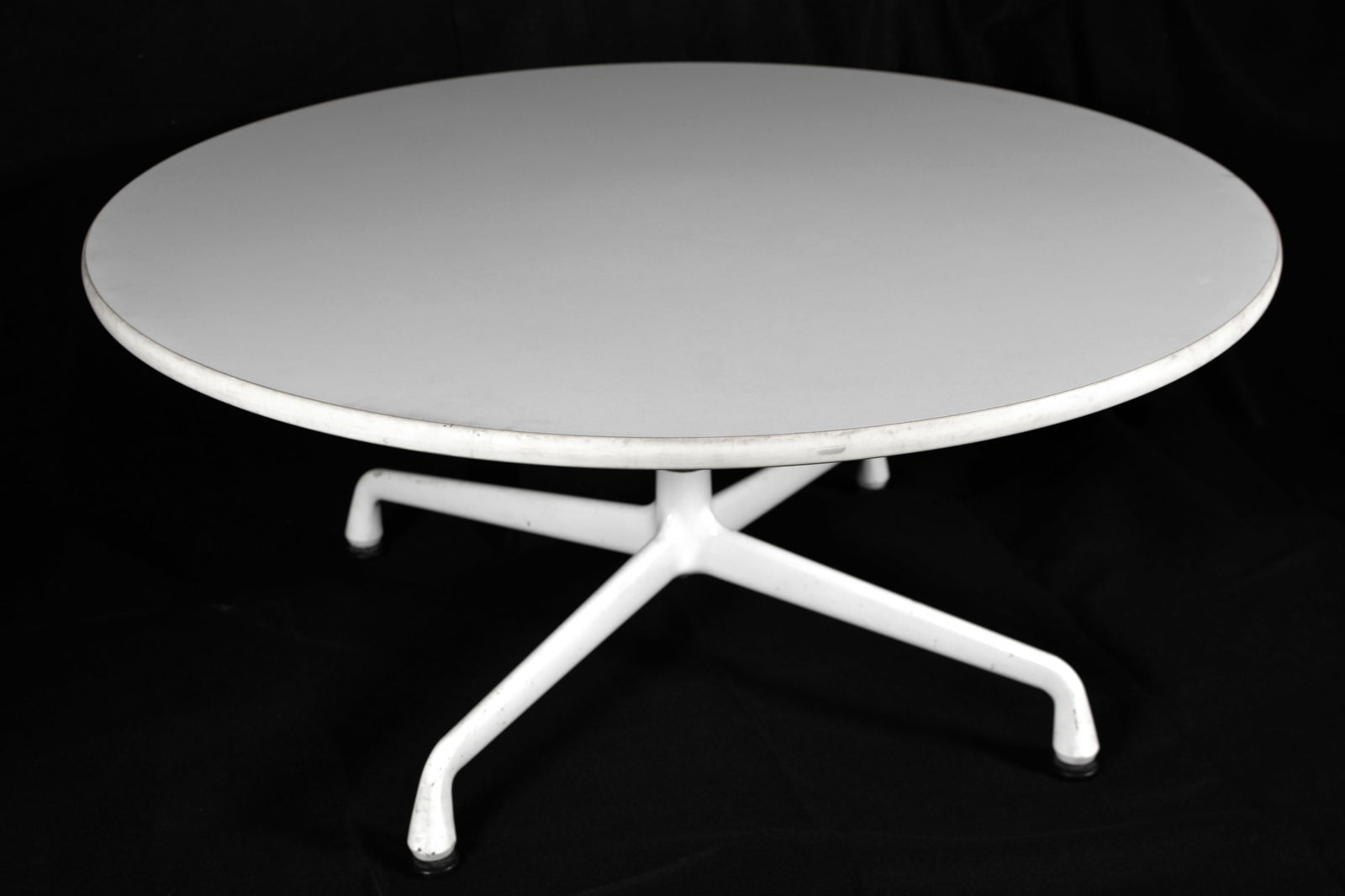 Charles Eames for Herman Miller Circular White Universal Coffee Table: Circular white Herman Miller Coffee table on universal base. Designed by Charles Eames. Measures approx. 36" in diameter and 16" tall. Herman Miller plaque on bottom.