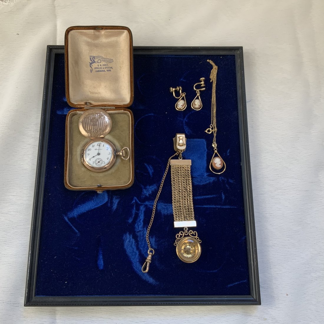 Antique Jewelry Lot: This lot includes an antique lady’s pocket watch with original box, a watch fob with attached compass, and a cameo necklace and earring set. All in good condition, the watch will need to be repaired