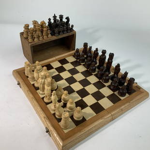 Folding Chessboard With Two Complete sets of Wooden Chessmen.: Folding Chessboard With Two Complete sets of Carved Wooden Chessmen.