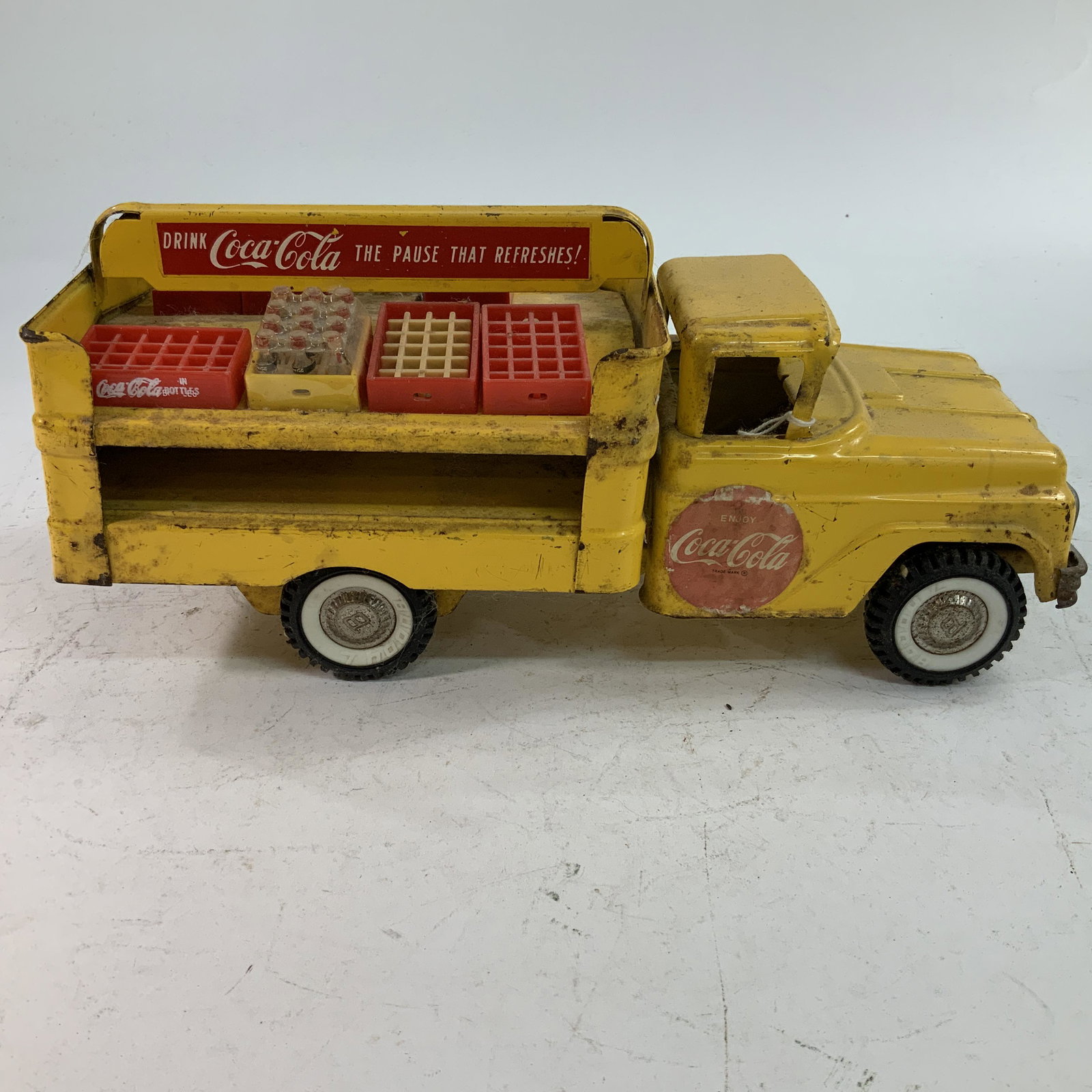 Buddy L Coca Cola Delivery Truck: Yellow Buddy L Coca Cola Delivery Truck, with coke cases and hand truck. Approx. 15" long.