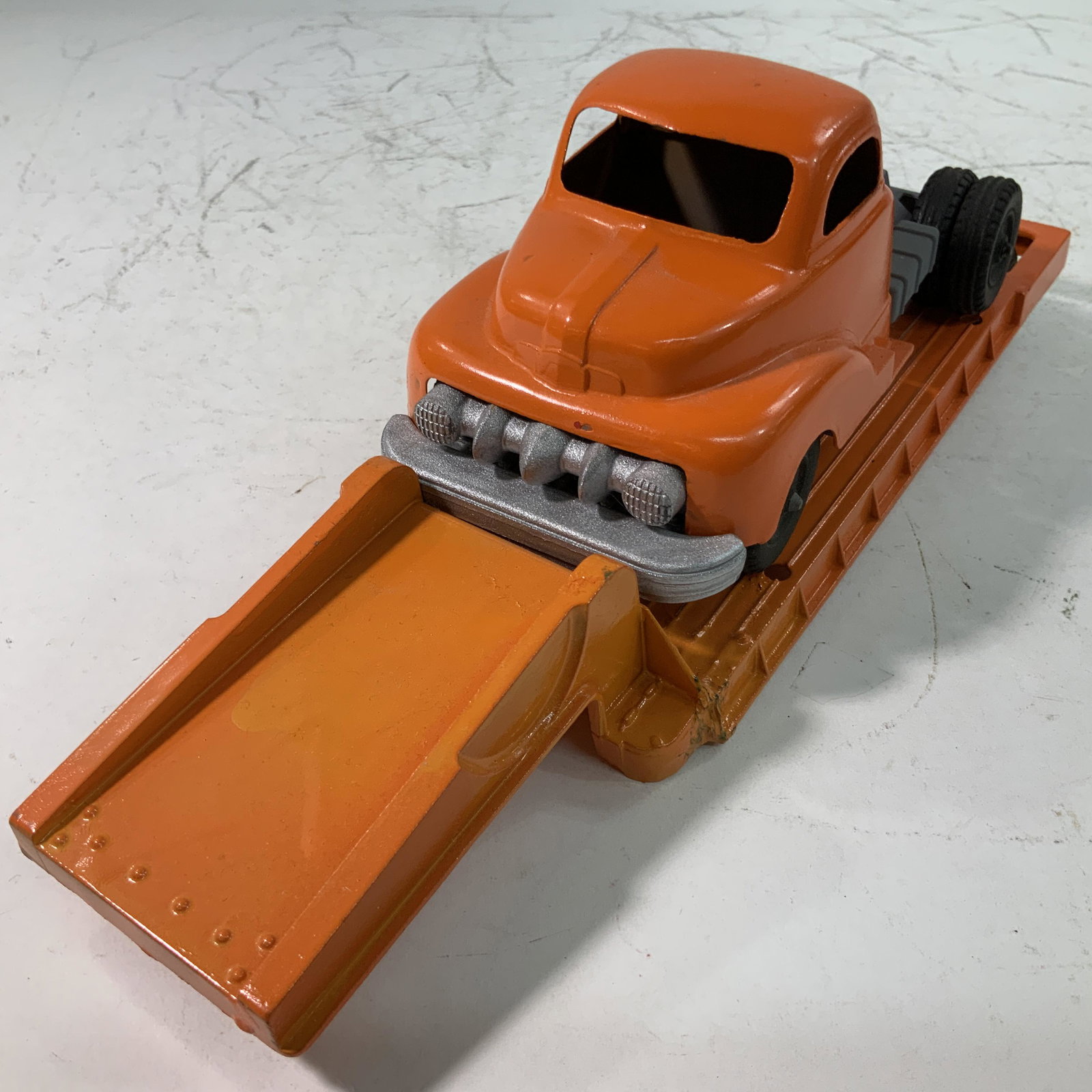 Hubley Lowboy Flatbed Truck: Orabge Hubley Lowboy Flatbed Truck. Approx. 19 1/2" long.