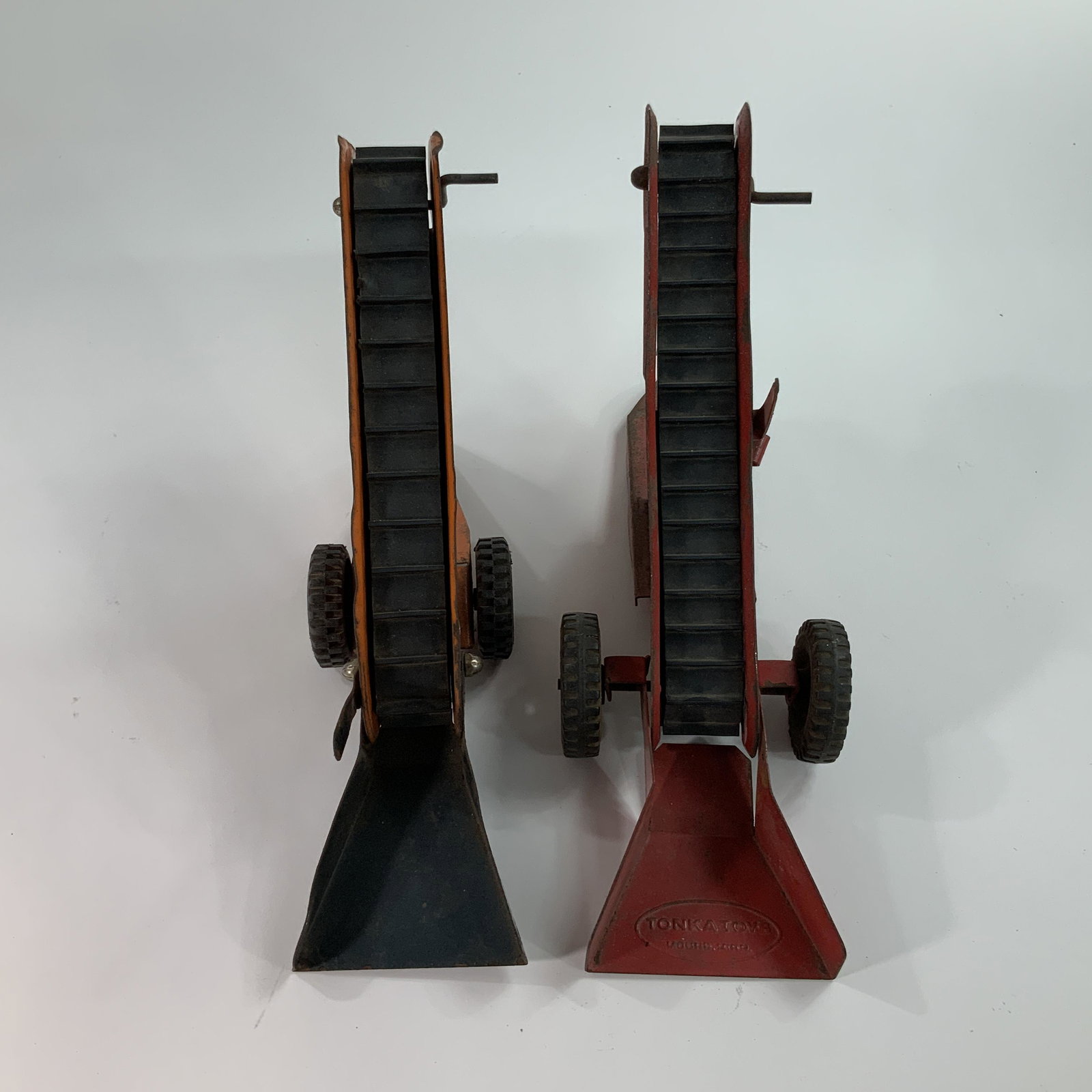 Two Sand Loaders: Two Sand Loaders- one orange Structo, approx. 12" long, and one red Tonka, also about 12" long.
