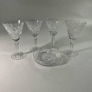 Waterford Crystal: Set of four Waterford Crystal wine glasses, approx. 6 1/2" tall. With a shallow circular tray or caddy for holding a wine bottle, approx. 5" diameter.