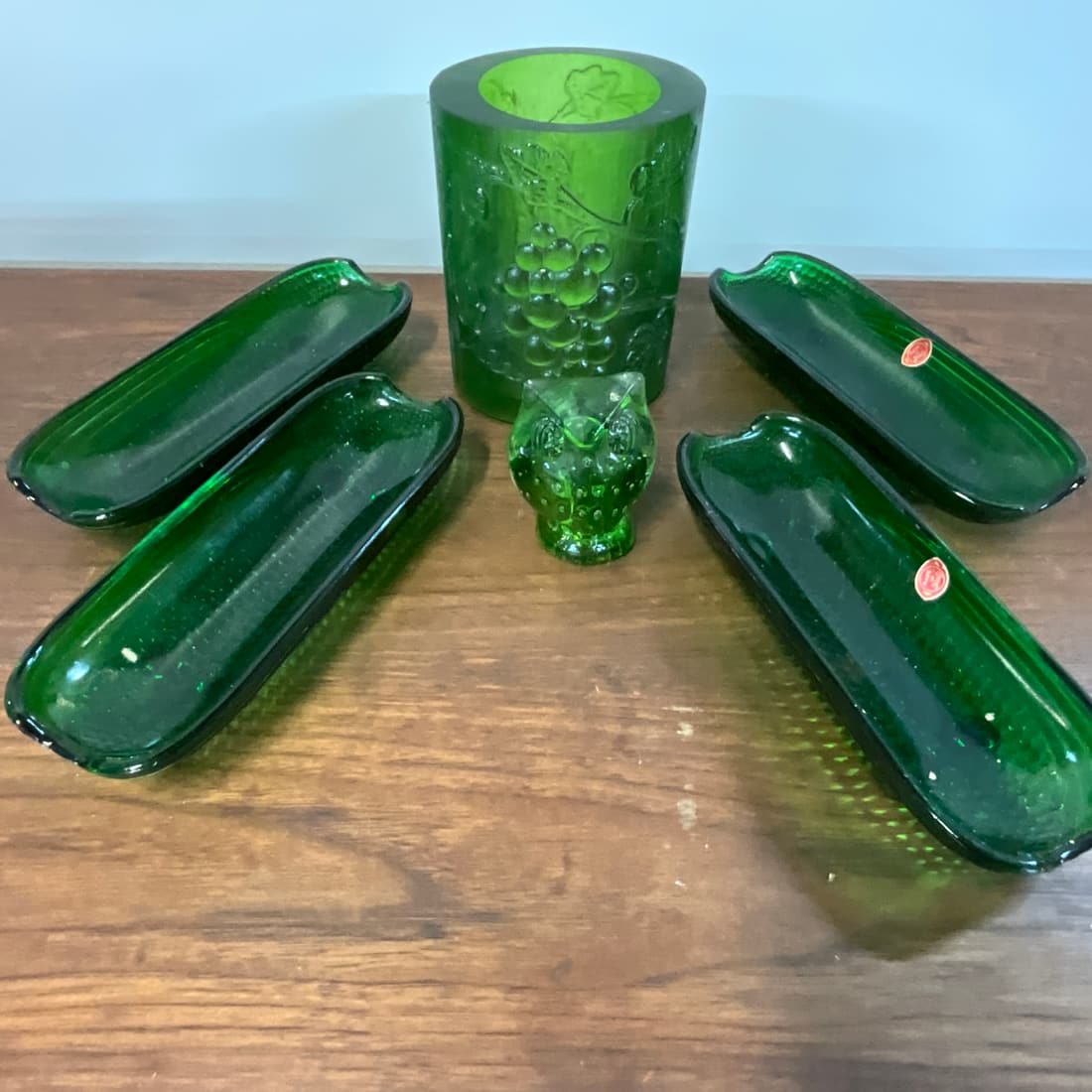 Green Glass Lot: Set of 4 corn dishes, made in Italy, approx. 8.25" long. A candle holder, approx. 5.75" high, and an owl paperweight, 3" tall.