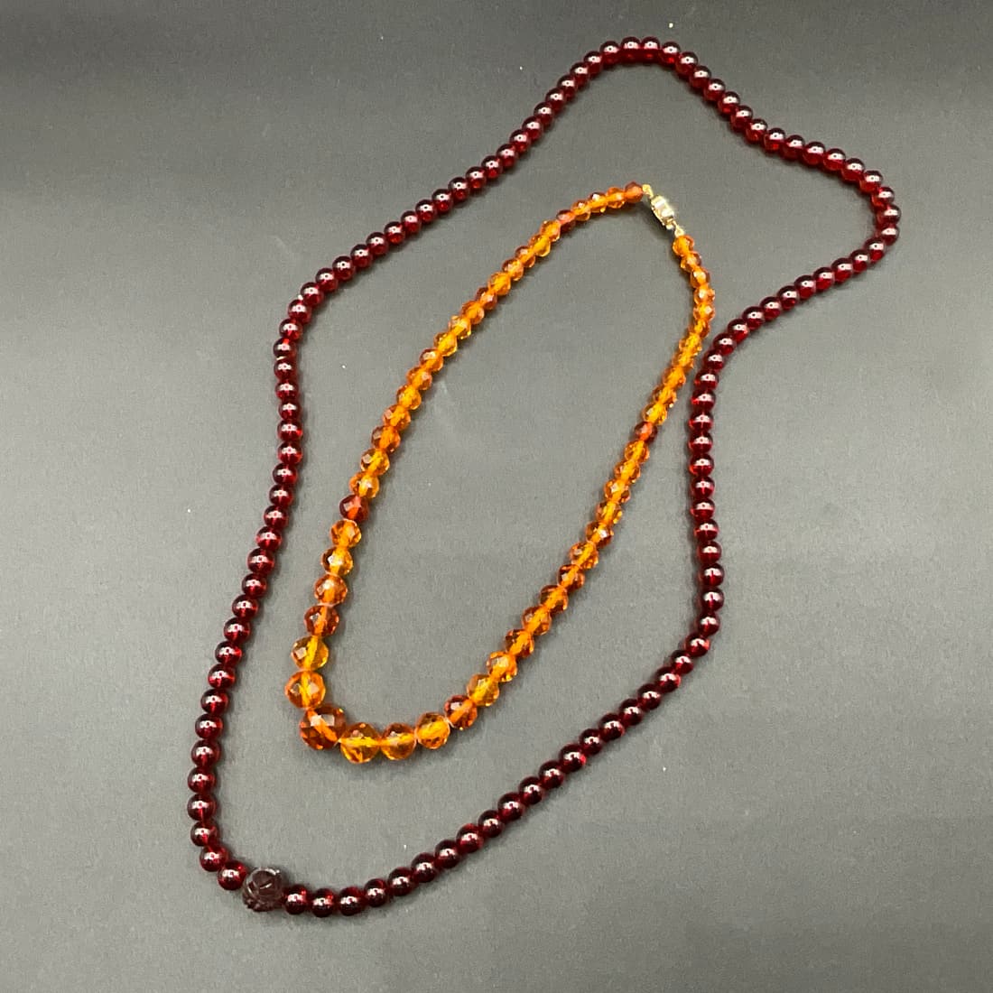 Baltic Amber Necklace and Another Necklace: Baltic Amber Necklace, approx. 17" and another necklace which exhibits no fluorescence when hit with a UV light 30" long.