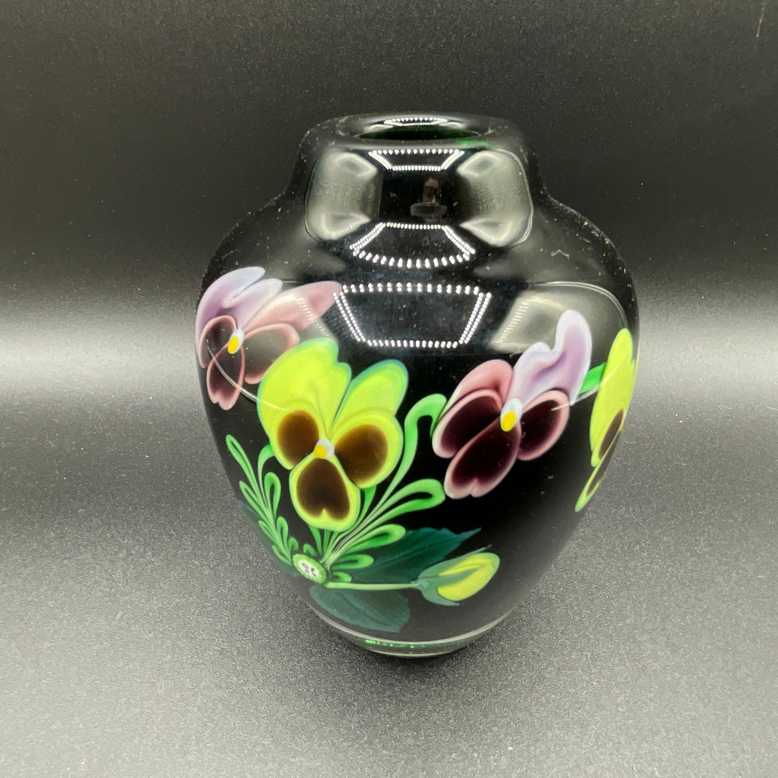 Paperweight Vase by Orient & Flume. : Pansy décor on black (dark green) background. Center of bouquet has white medallion: "OF 84" which means "Orient & Flume, 1984". Signed on the bottom by artist Hudin, as well as the Orient & Flum