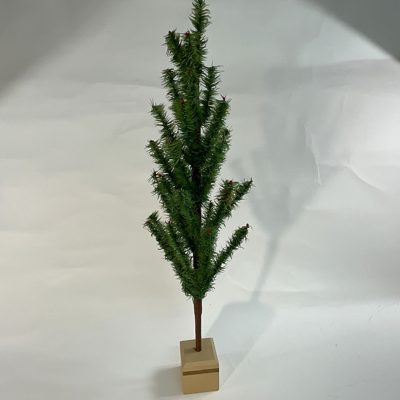 Christmas Feather Tree: Antique style with red berries on the tips, signed and dated 2000, handmade by Twins Feather Trees, signed on base. Height including base: 33". Spread at widest: 16".