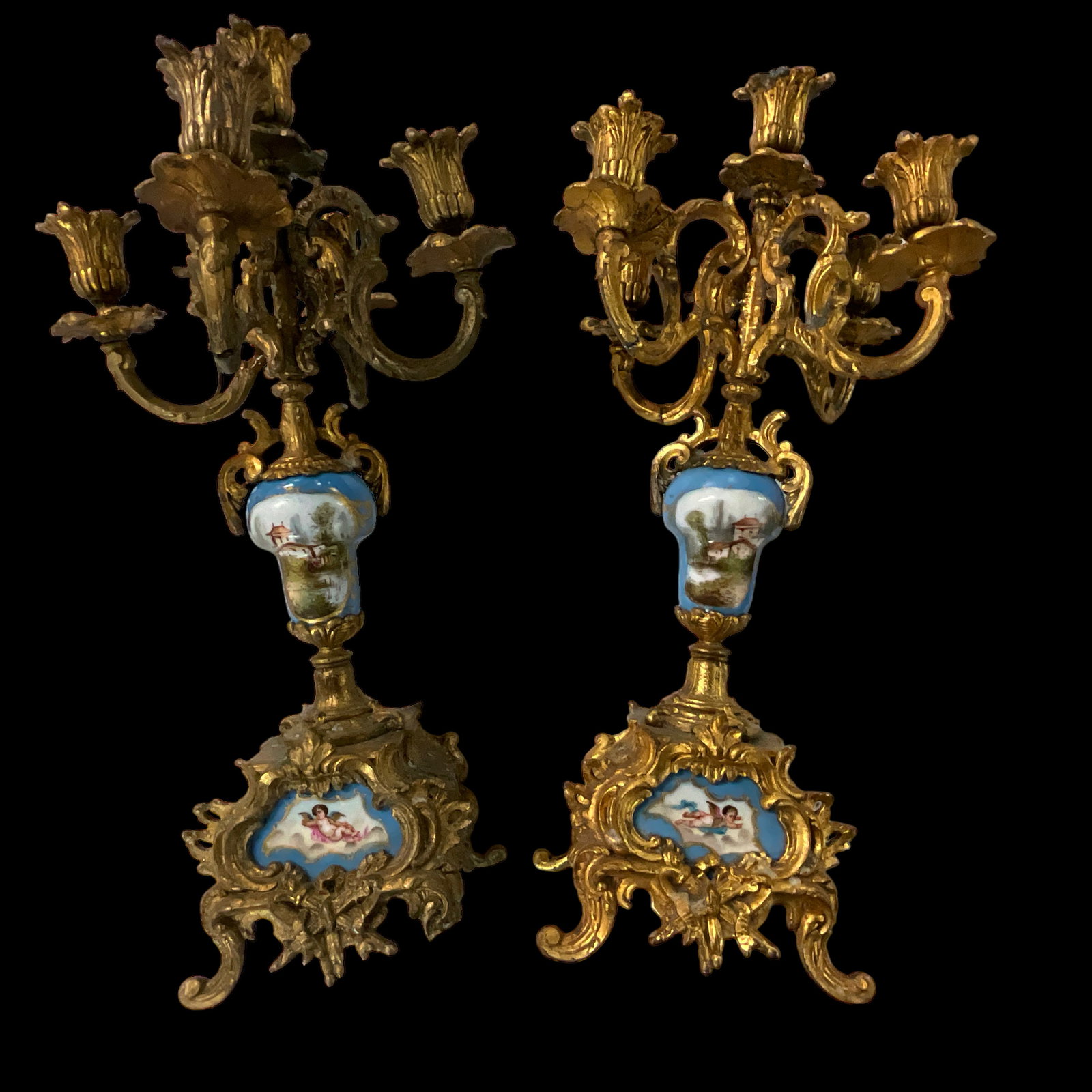 Sevres Style Candelabras: A pair of Sevres style 5 candle candelabras- gilt bronze with porcelain stems and plaques. Approx. 18" tall.One has a broken leg...