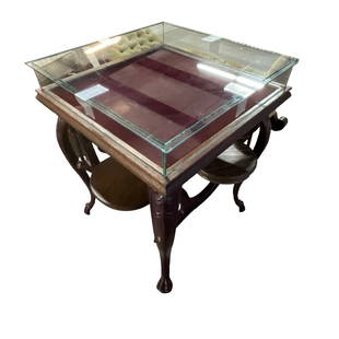 Victorian Jewelry Store Display Table: Victorian Jewelry Shop display table. Hinged glass display section (loose top glass) opens to provide access. The table has iron legs and four pivoting attached seats with iron brackets and circular w