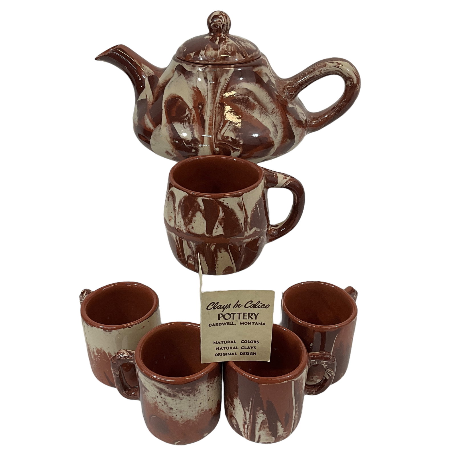 Clay in Calico Pottery Teapot w/cups and mug: Clays in Calico Teapot with lid and cups (4), mug (1). Total of 6 items