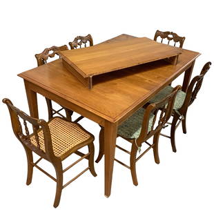 Ethan Allen Dining Table w/Leaf and Six Cane Seat Chairs: Ethan Allen dining table w/one leaf and 6 cane seat chairs (one chair has top center portion missing on chair back decoration). Table measures approx. 56" long (excluding leaf) x 36" wide, 30 1/2" tal