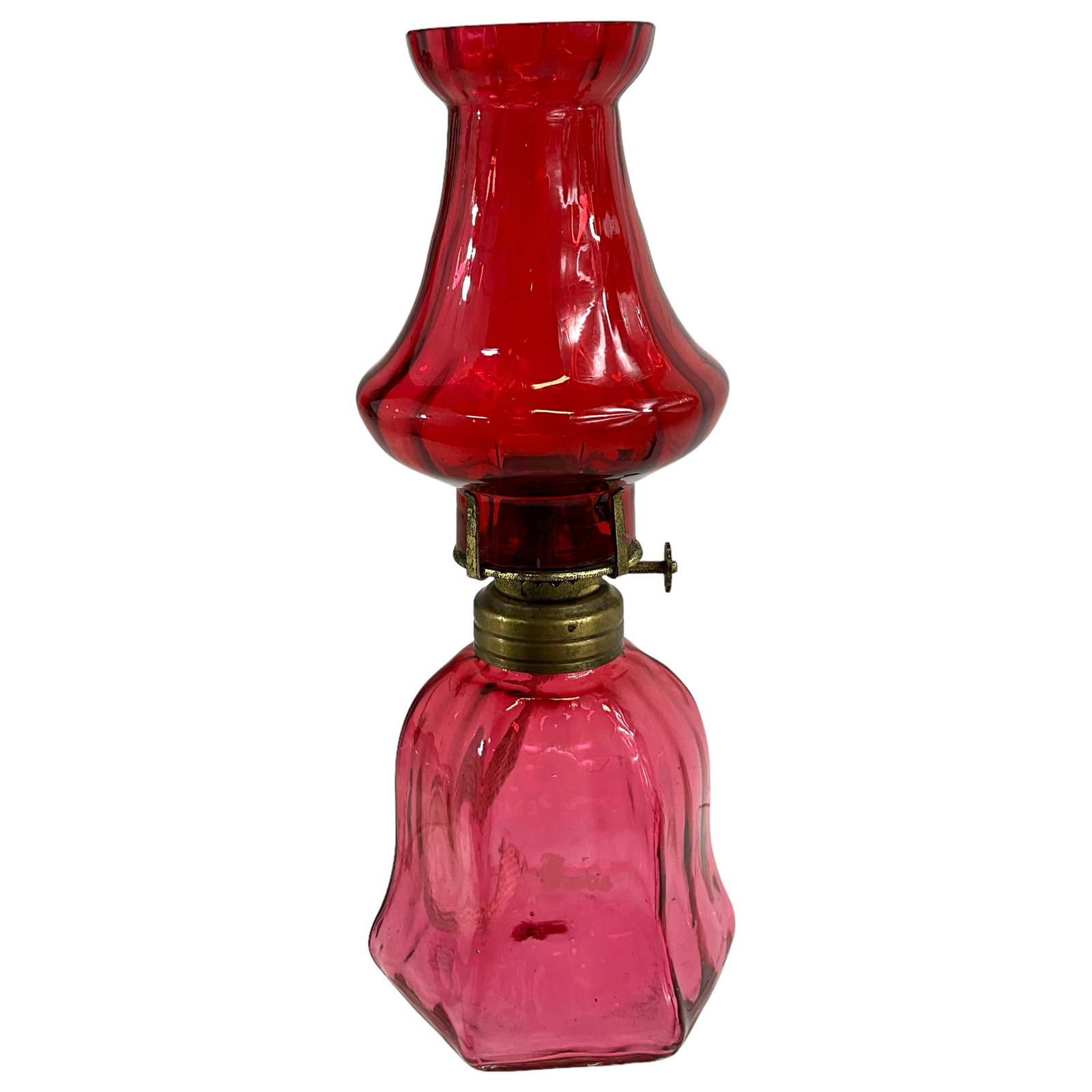 Miniature Victorian Oil Lamp, Cranberry Glass: Miniature victorian oil lamp in cranberry glass featuring a slightly twisted pattern. INcludes base, shade, and burner. Measures approx. 8 3/4" tall, 3 1/2" diameter.