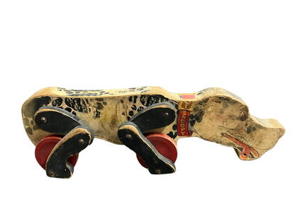 Early Fisher-Price "Snoopy Sniffer": Early Fisher-Price "Snoopy Sniffer" Manufactured between 1938 and 1957, this one is well used. Graphics are worn, ears and leash are gone, and he drags one leg. Still a classic.