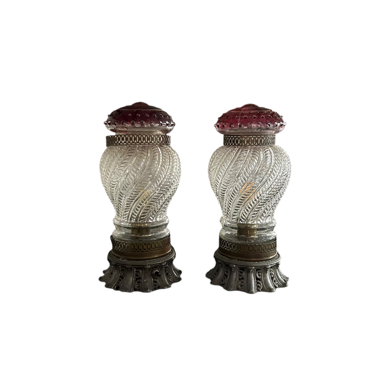 Pair of 1930's lamps: Pair of 1930's lamps- Spelter bases with rotary switches, spiral pattern glass shades with cranberry tops and metal lattice trim. They appear to have been re-wired.