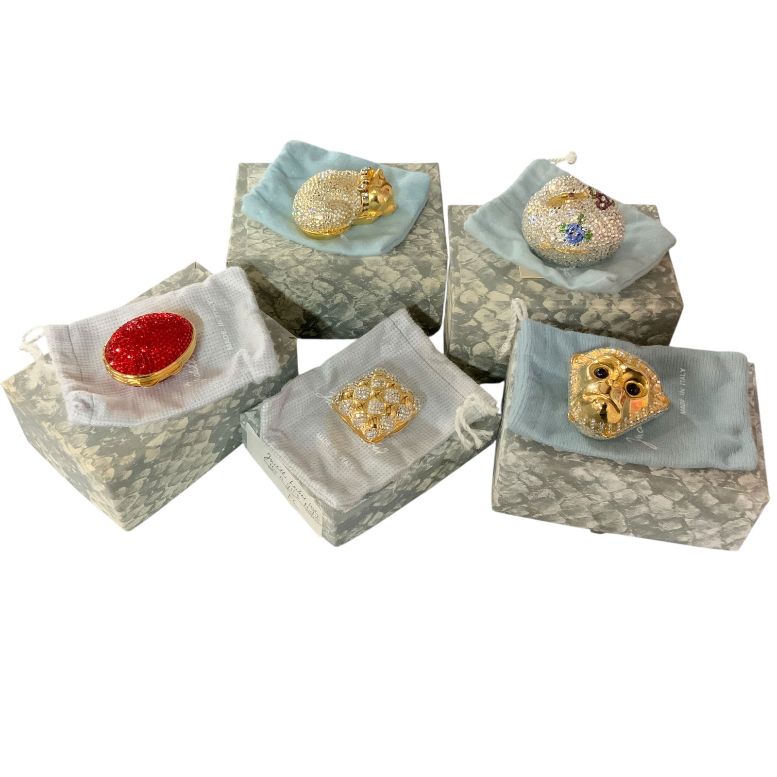 Collection of 5 Judith Leiber Pill/Trinket Boxes: Judith Leiber, a Hungarian-American fashion designer, established her company in 1963 following her emigration from Nazi-occupied Hungary. Her designs, utilizing materials such as Swarovski crystals,
