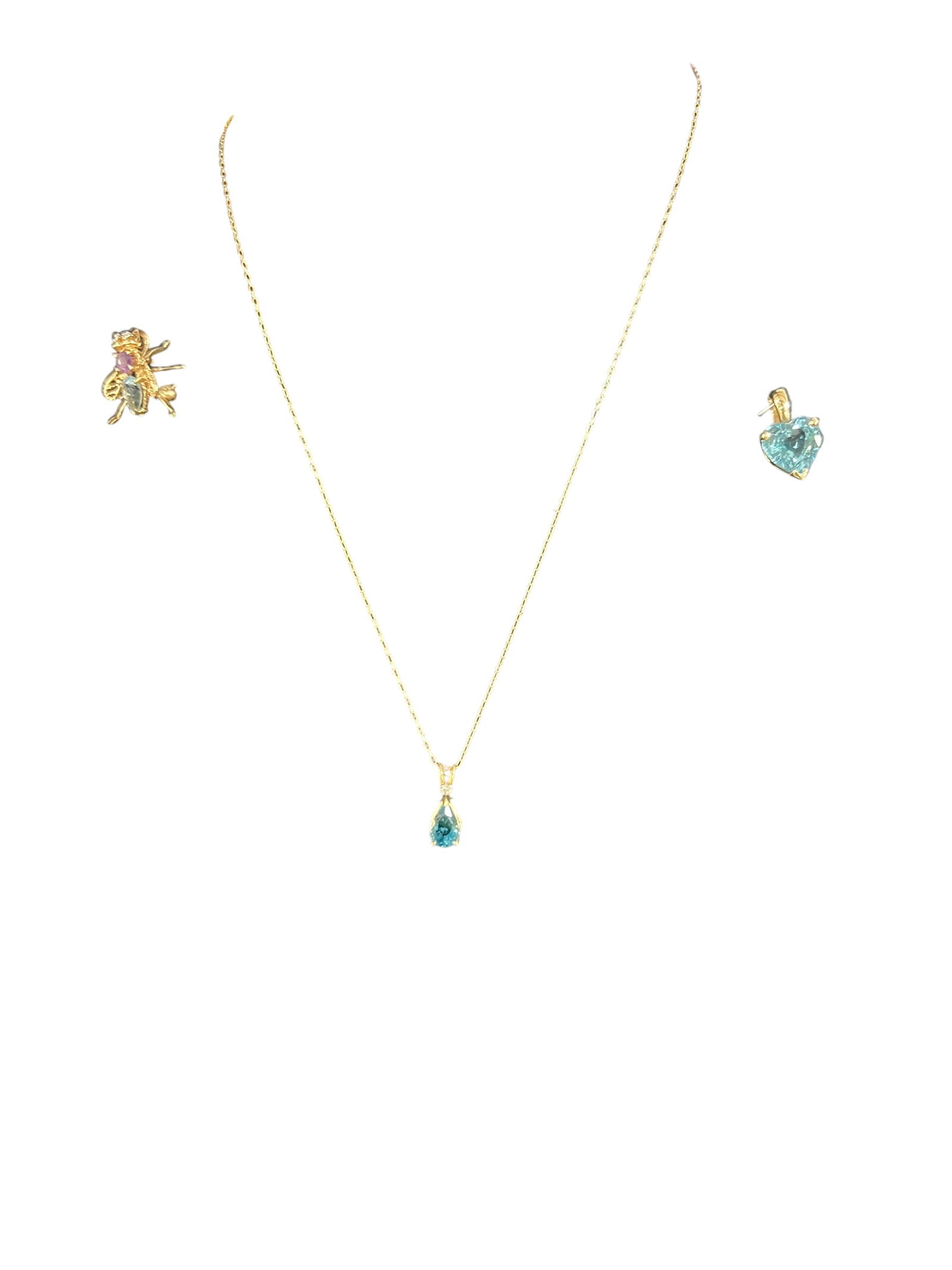 Semi Precious Colored Stone Jewelry: Eighteen inch 14k chain with a 14k diamond and aquamarine pendant. Heart-shaped blue Topaz pendant stamped 14 ktp. A Diamond, Topaz and Amethyst pin stamped 14 karat in the shape of a charming bee. TW