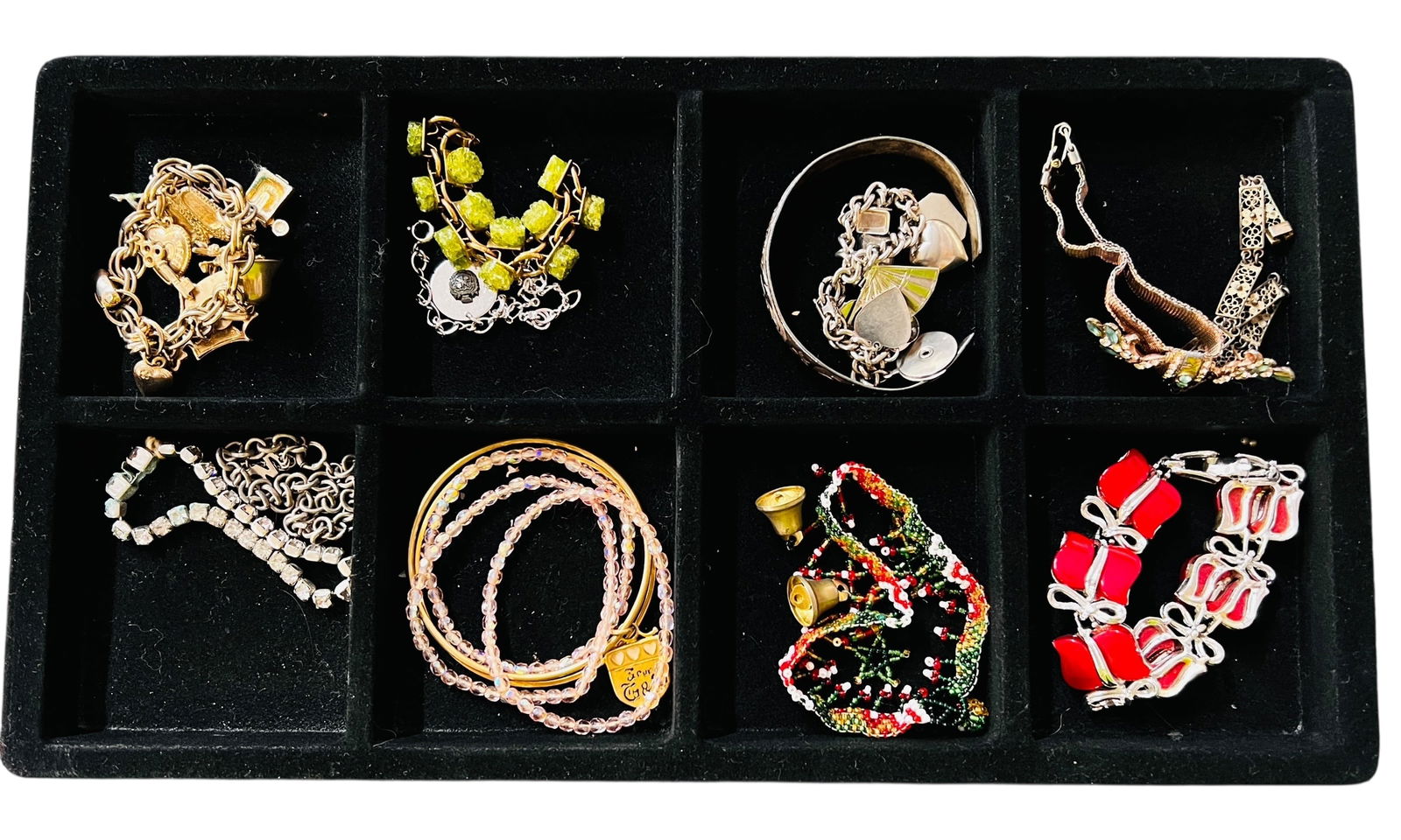 Collection of Vintage Bracelets: A collection of vintage costume jewelry bracelets in various designs. The lot includes 16 Pieces including 2 Coro charm bracelets, 1 silver tone 1 gold tone. Two sterling silver bracelets; one a fine