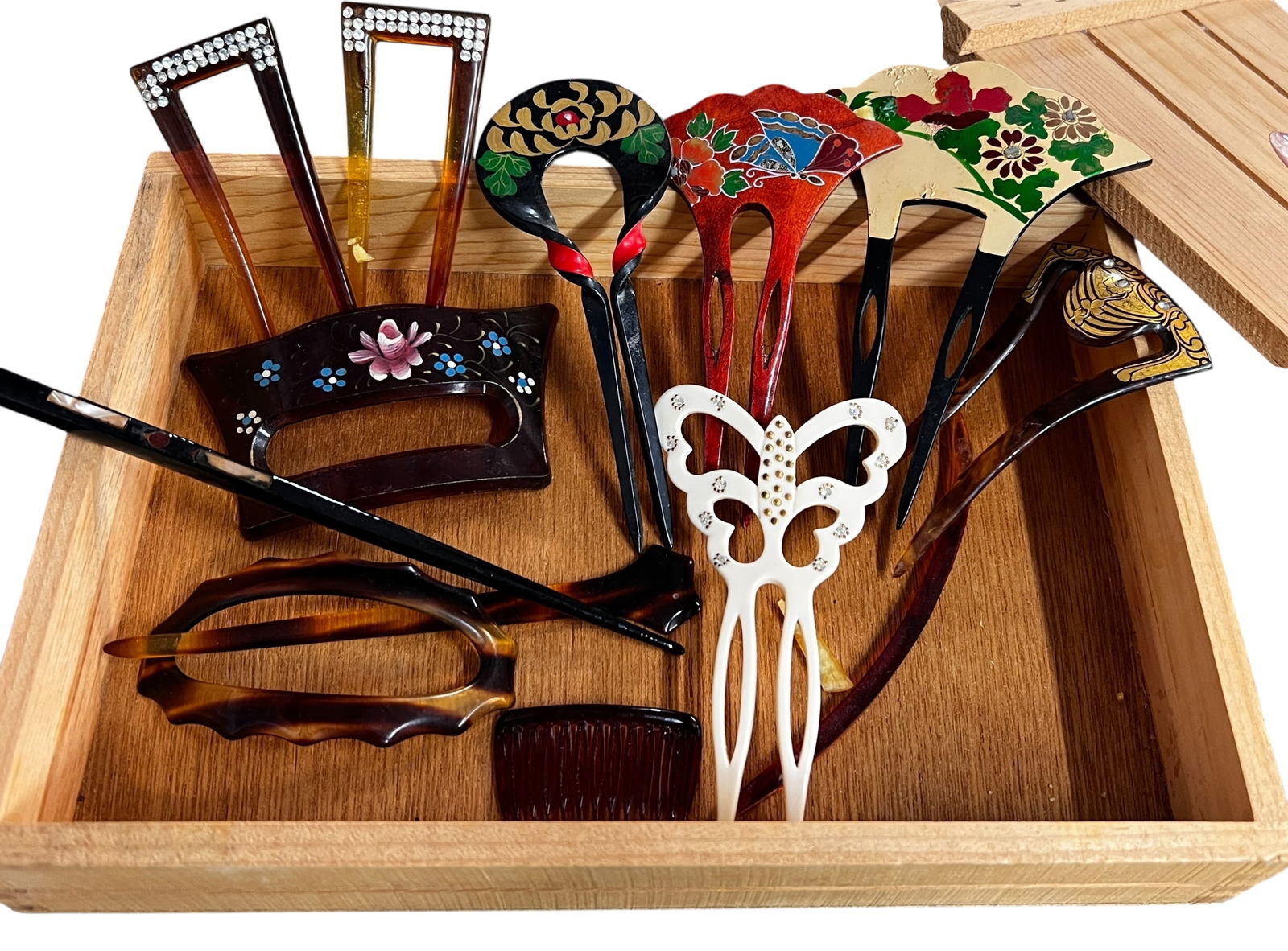 Vintage Hair Combs: Lovely collection of 12 vintage hair combs and picks. Ages range from antique to modern. Most are form of plastic and many are hand painted, the chopstick pair has inlaid MOP. The Rhinestone pair are