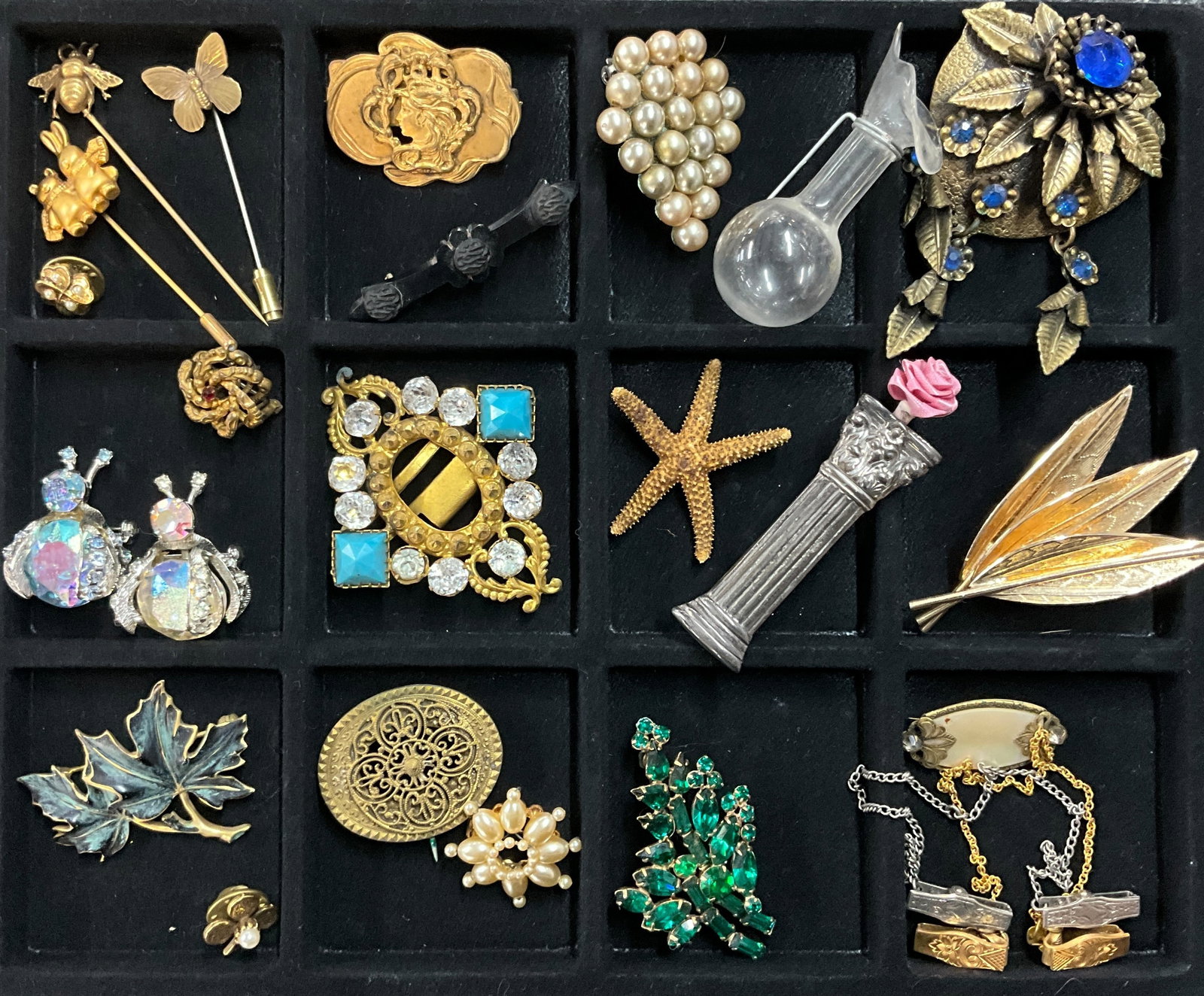 Vintage Jewelry-Brooches/Pins: Twenty-One vintage brooches/pins of various design, materials and eras. There is also a faux pearl shoe clip and an art nouveau belt buckle. The "Column" pin with the flower is marked Sterling.See pho