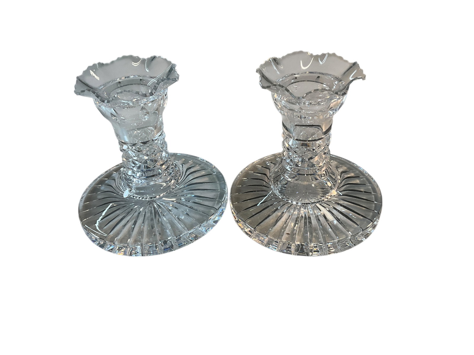 Waterford Crystal Lismore Candlesticks: Waterford Crystal Lismore Candlesticks. Signed on lower edge. Each is approx. 4.5" in diameter, and stands 4" tall. Includes a pair of delicate ruffled drip cups which may or may not be original to th