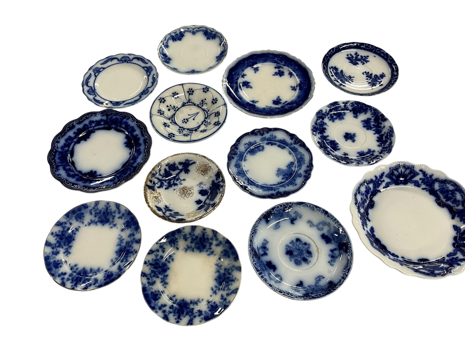 Group of Flow Blue Plates & Dishes: Group of Flow Blue Plates & Dishes. Mostly small sauce dishes. Makers include Grindley, Cliff, Lancaster, Touraine, and P. Gunthey's