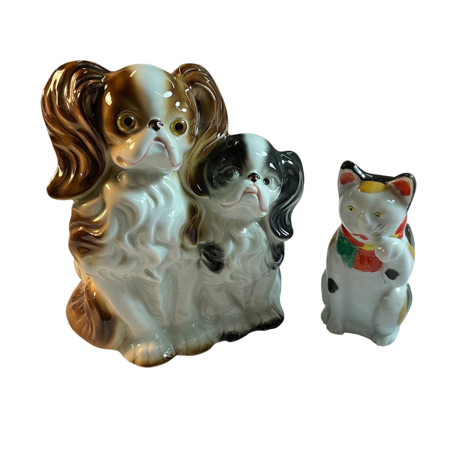 Porcelain Dogs & "Maneki Neko" Cat: Porcelain Dogs & "Maneki Neko" Cat. A pair of glossy glazed Pekingese or Cavalier King Charles Spaniels, unmarked but likely German. Also a "Maneki Neko" (Beckoning Cat) figurine, a good luck symbol f
