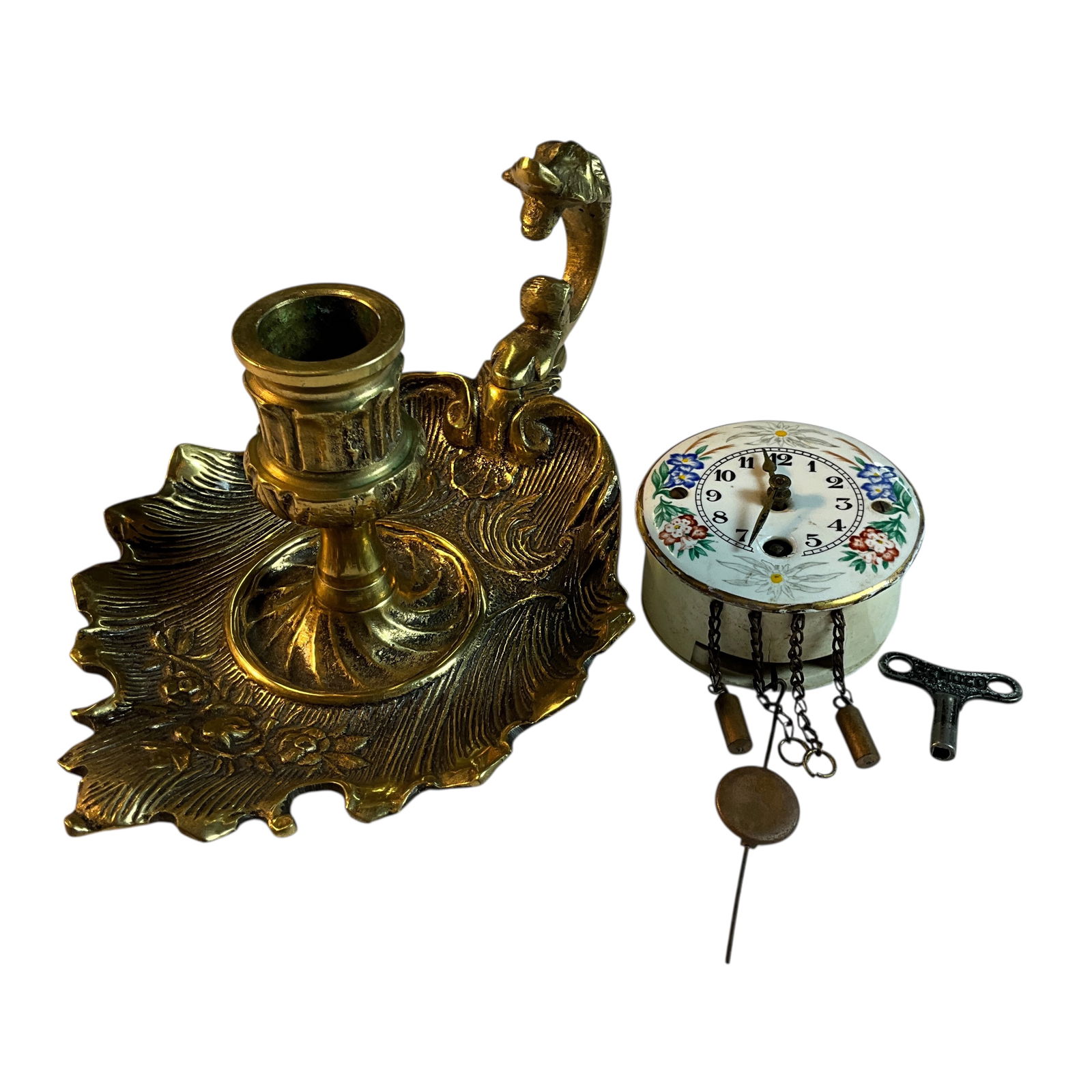 Miniature Wall Clock and Bronze or Brass Chamberstick: Miniature Wall Clock and Bronze or Brass Chamberstick. Tiny wall clock measures only 2.5" in diameter, and is complete with key, pendulum, and tiny weights. Bag has label stating "Runs good." Chambers