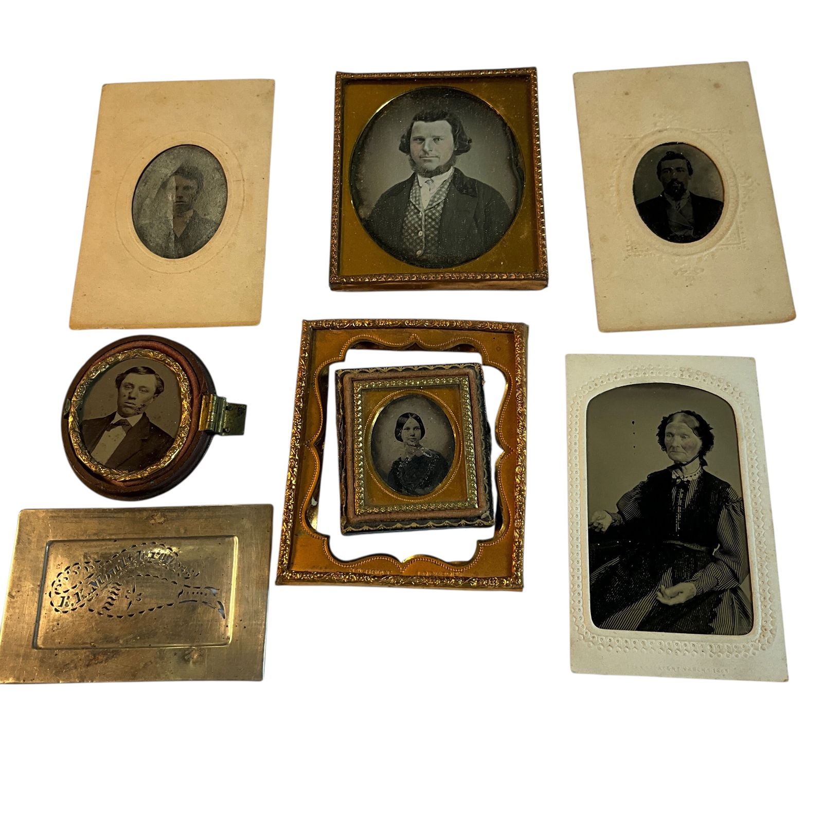 Group of Victorian Photos: Group of Victorian Photos. Three tintypes in paper sleeves, a daguerreotype in a copy inner frame from a cased photo, and a tintype in an oval union case which is missing the cover. There is also a lo