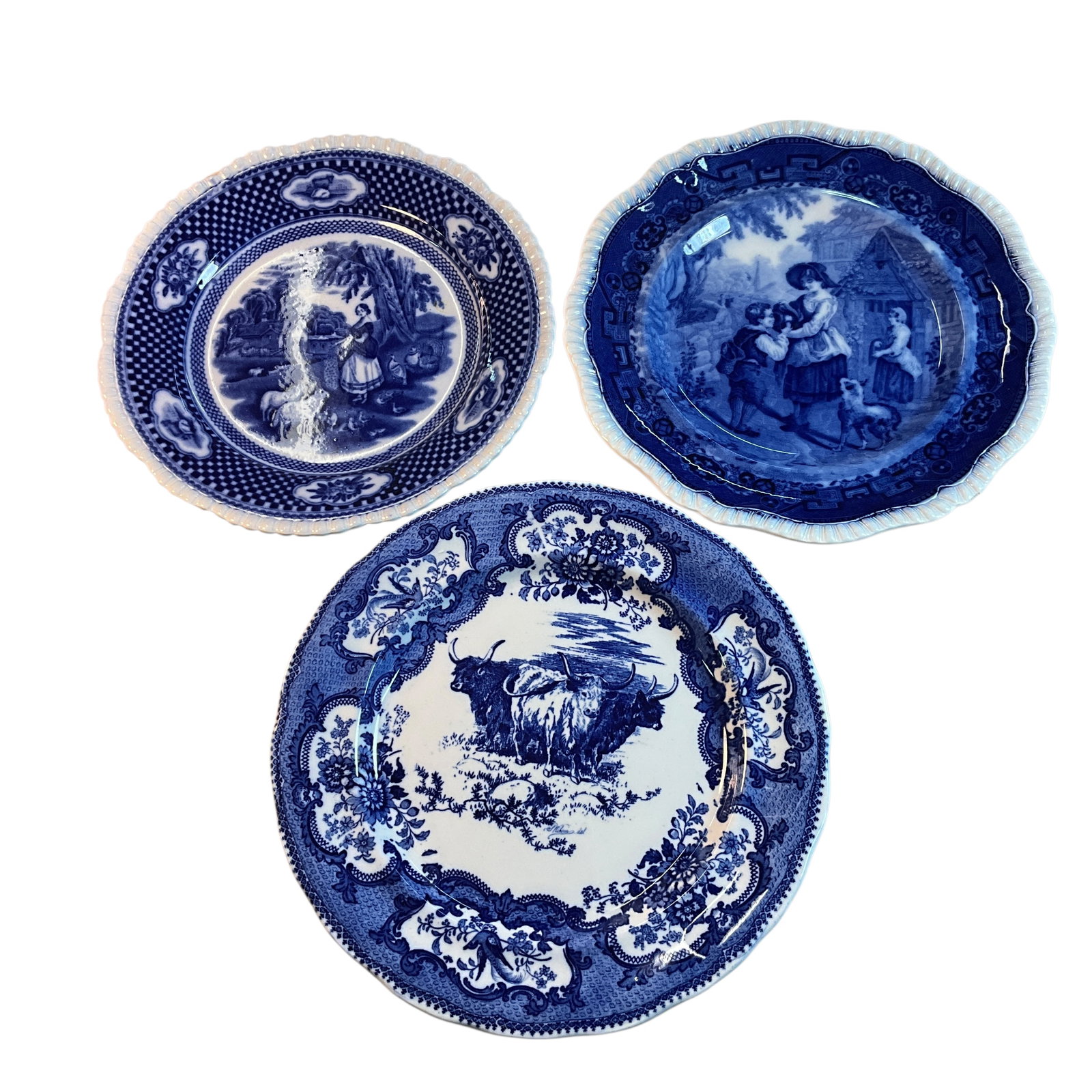 Trio of Flow Blue Plates: Trio of Flow Blue Plates. A W. Adams & Co, "Old English Rural Scenes," a Copeland England plate, and a Doulton Burslem plate featuring Highland cattle. Largest is 10.75" in diameter.