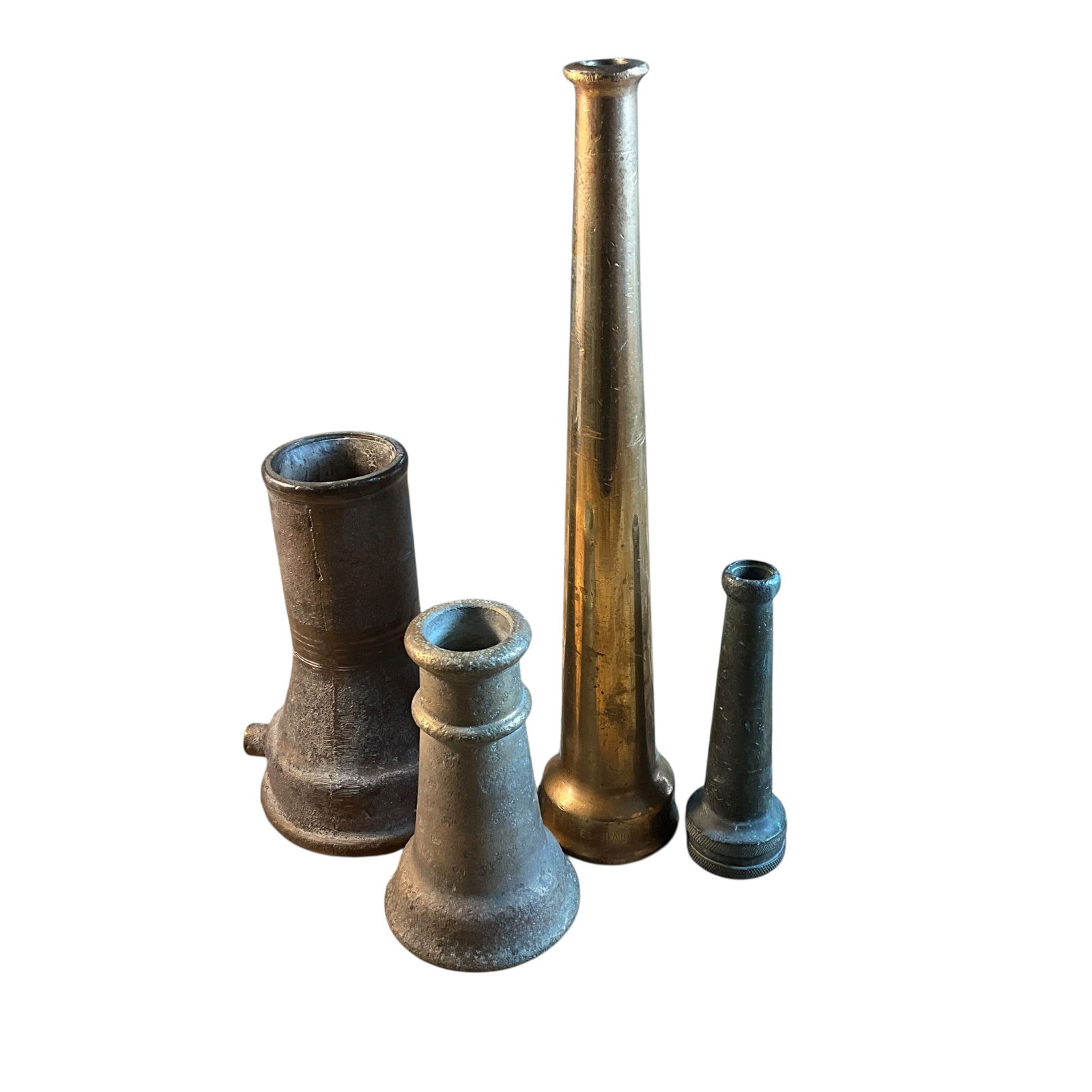 Group of Four Brass or Bronze Firefighting Nozzles: Group of Four Brass or Bronze Firefighting Nozzles. Various sizes and types, with small wooden "dog bone" display stands. Largest nozzle is approx. 12" Long