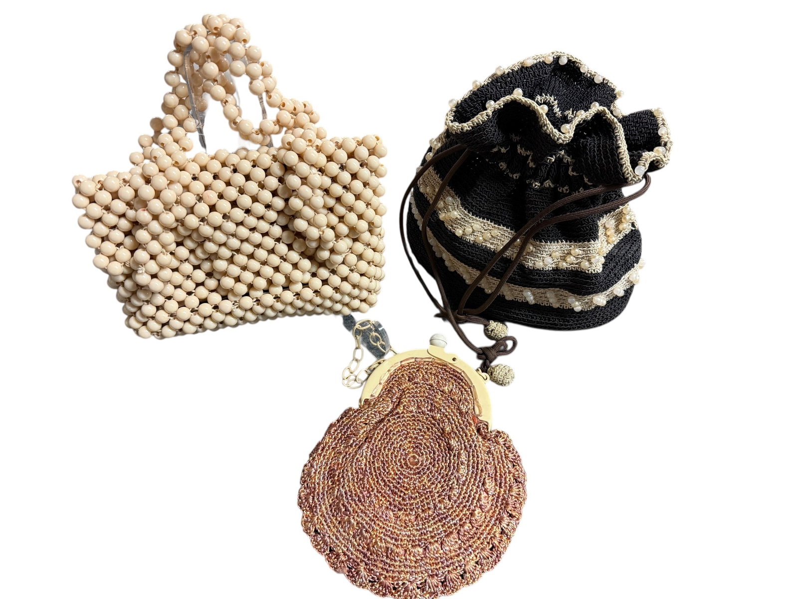 Vintage Handbags: The first handbag on the left is a Sarne bag made entirely of cream-colored beads, forming both the body and the handles in a neat, grid-like pattern. It has a sculptural, almost architectural feel du