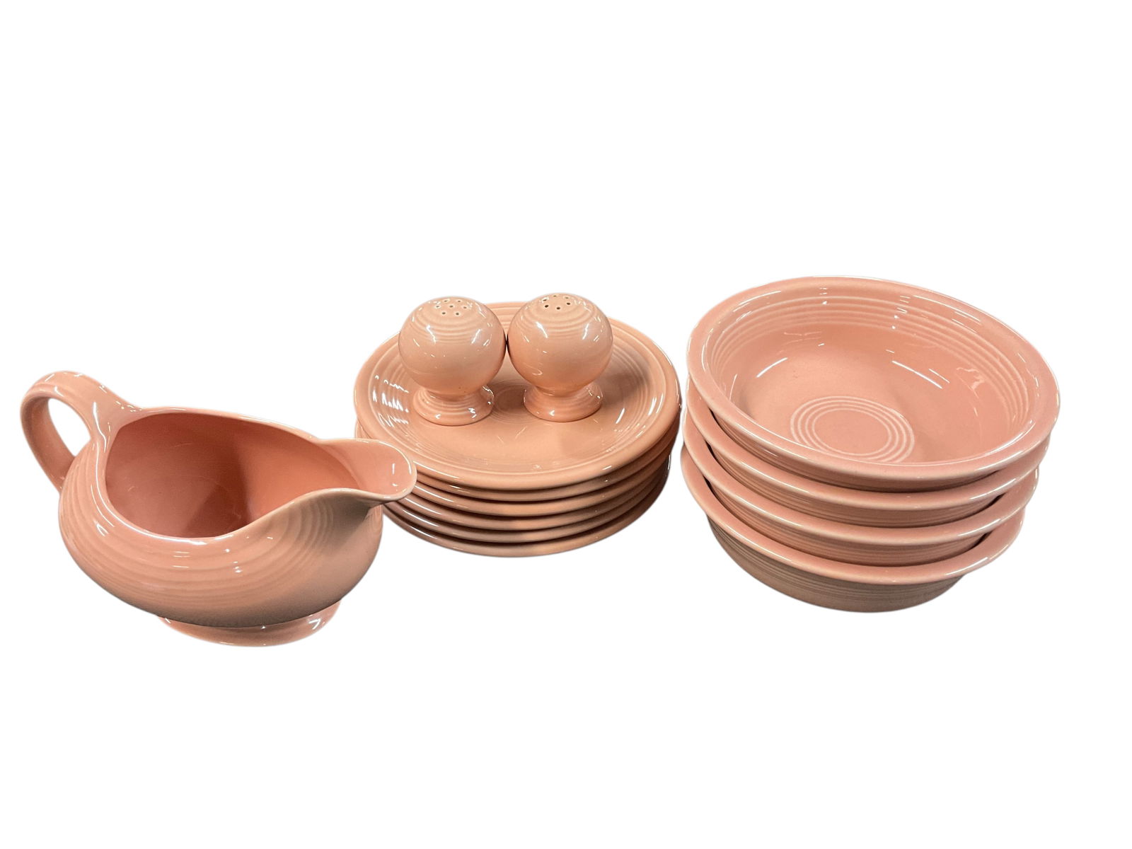 Fiestaware Grouping, Apricot Colorway: Fiestaware Grouping, Apricot Colorway. The Apricot colorway was produced from 1986-1998. This group consists of a gravy or sauce boat, salt & pepper shakers, four 7" bowls, and six 7" plates. No