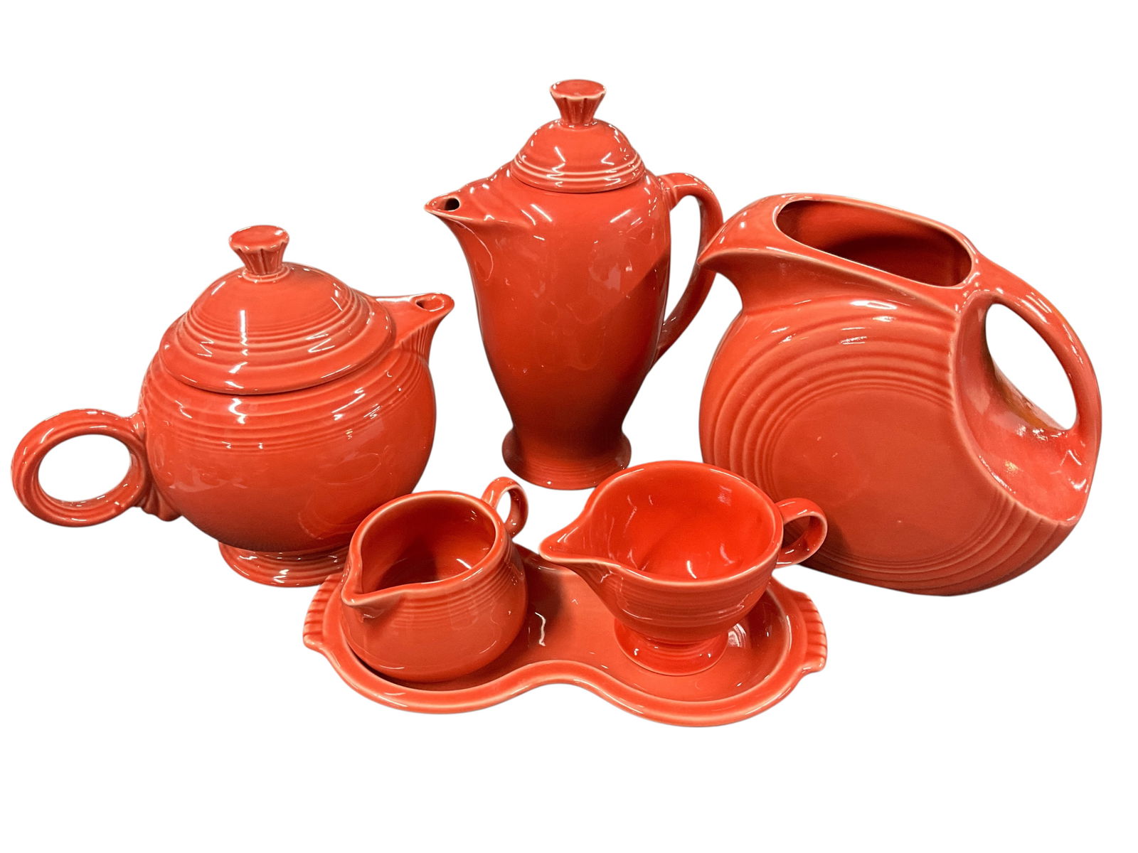 Fiestaware Grouping, Persimmon Colorway: Fiestaware Grouping, Persimmon Colorway. The Persimmon colorway was introduced in 1989, and has since been retired. This group consists of a 7" high disc pitcher, a 7.5" teapot, a 9" coffee pot, and