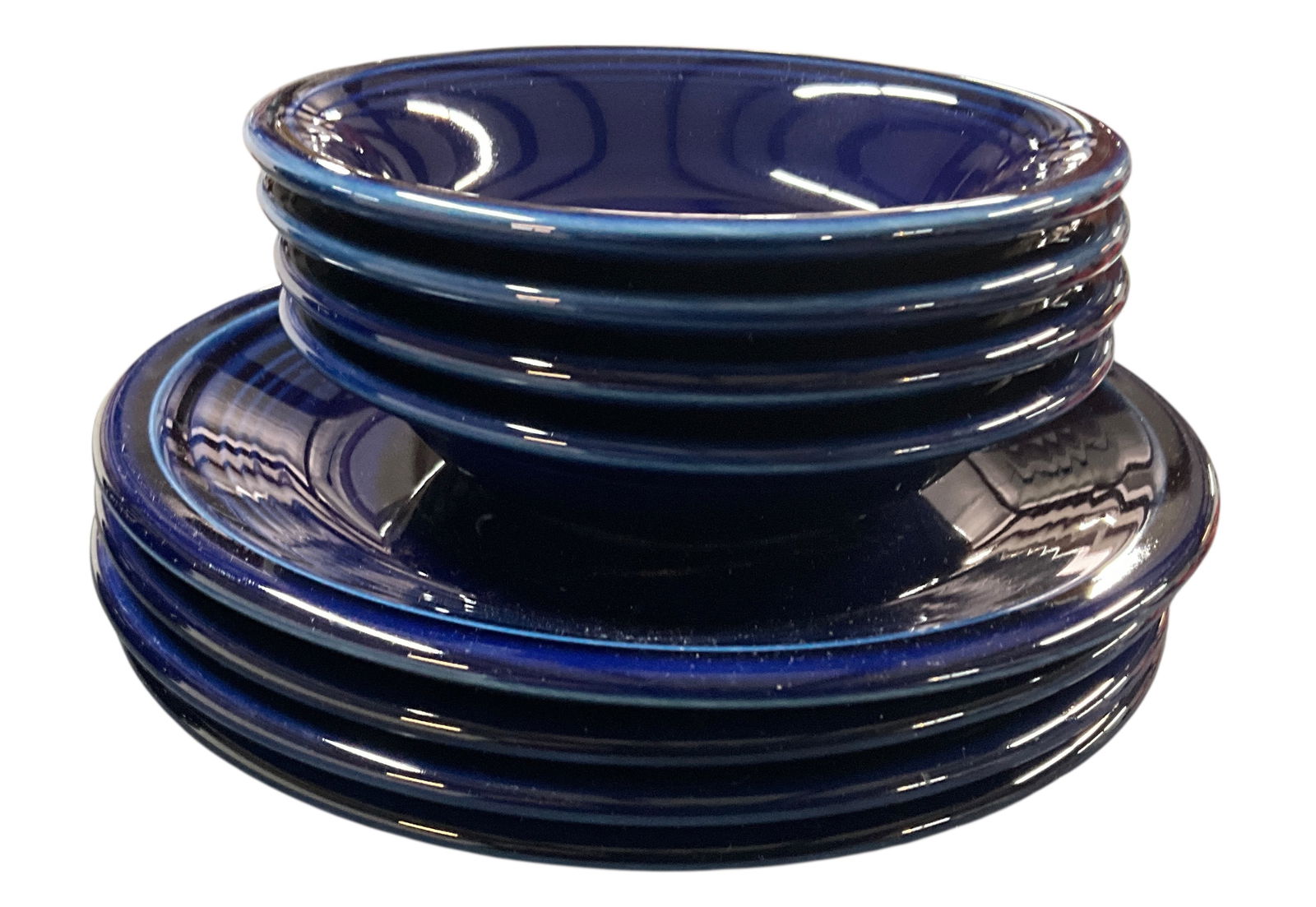 Fiestaware Grouping, Cobalt Blue Colorway: Fiestaware Grouping, Cobalt Blue Colorway. The Cobalt colorway was produced from 1986-2021. This group consists of an 8" Round pitcher, four 5" sauce dishes, four 7" plates, and twelve 7" bowls. No