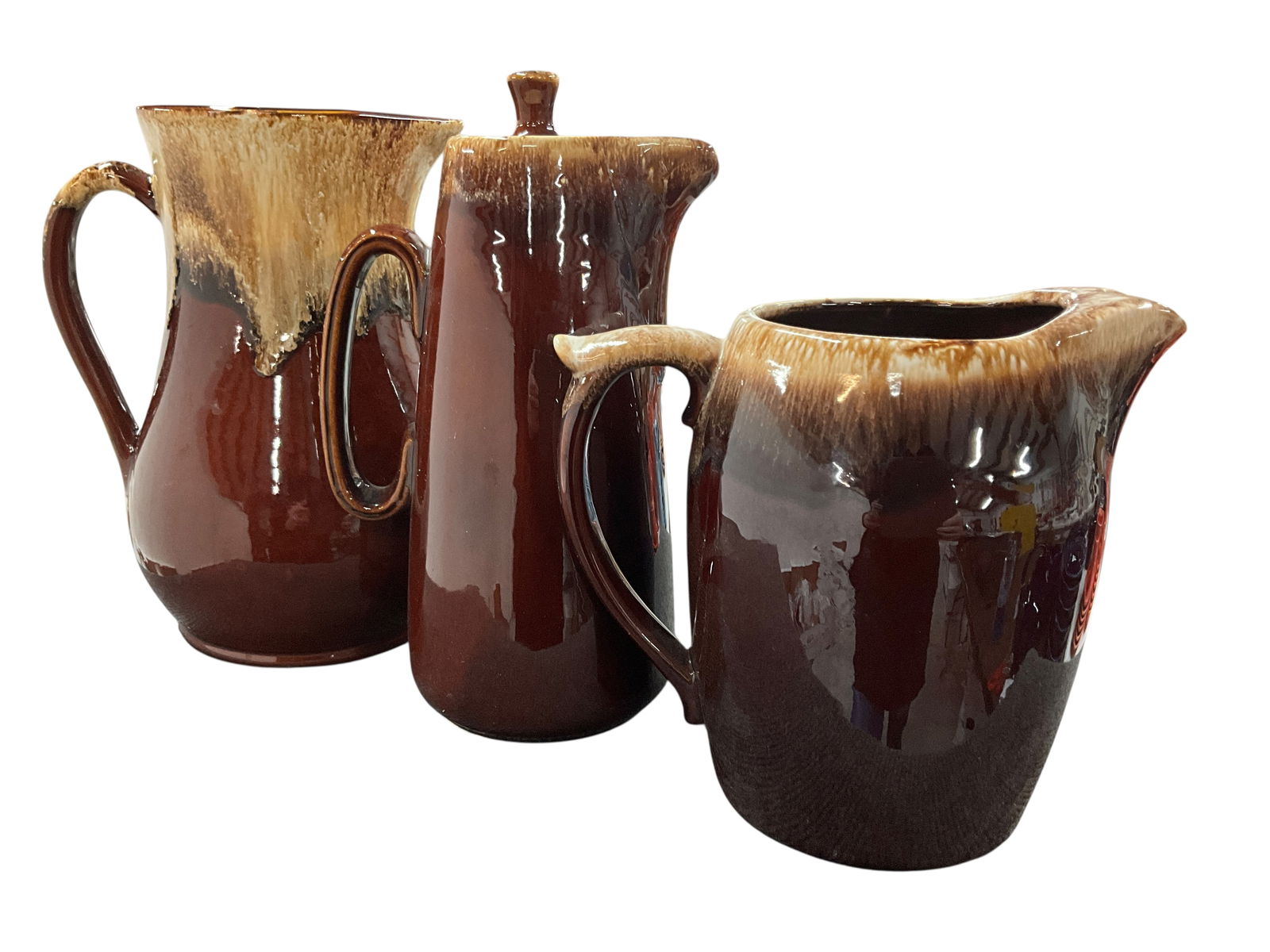 Trio of Bennington Style Pitchers: Trio of Bennington Style Pitchers- an 11" Robinson Ransbottom, an 11.5" Hull with lid, and an 8.25" pitcher marked only with "USA" on bottom, that is likely Shawnee.