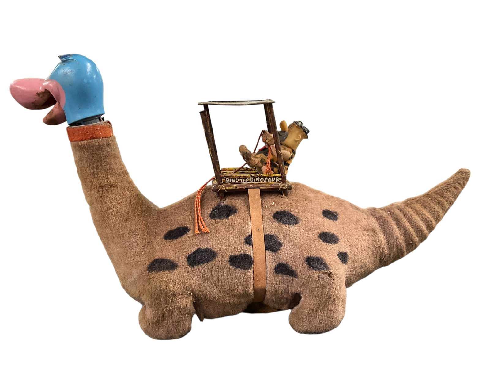 1960's Fred Flintstone Dino-Toy: 1960's Fred Flintstone Dino-Toy, by Marx. Battery operated stuffed plush toy dinosaur, ridden by Fred Flintstone. When working, the dinosaur walks with a "bump and go" action, and moves his head back
